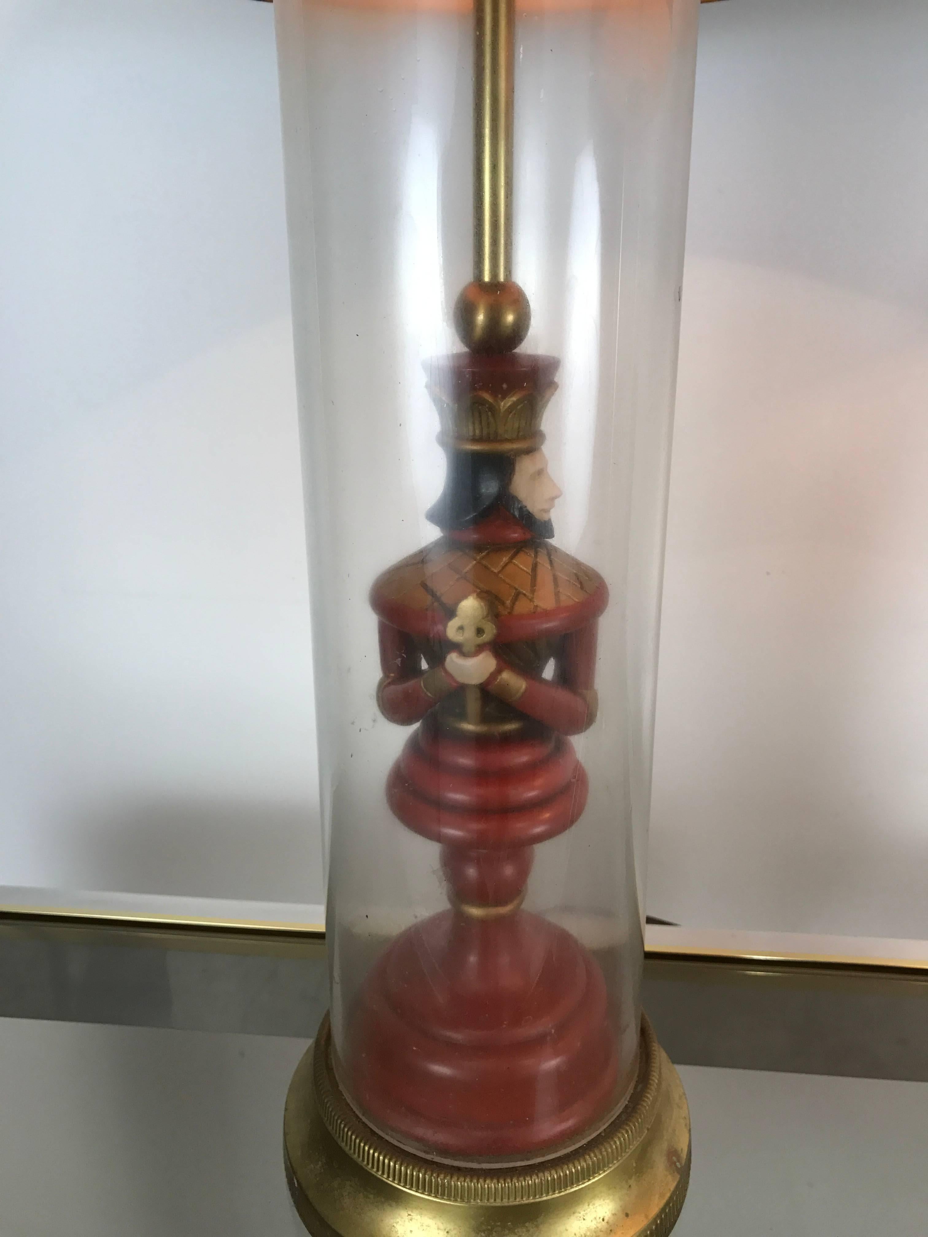 Unusual pair of decorator lamps, chess themed king figures encased in glass cylinders. Retain original lamp shades and finials. Shades measure 15