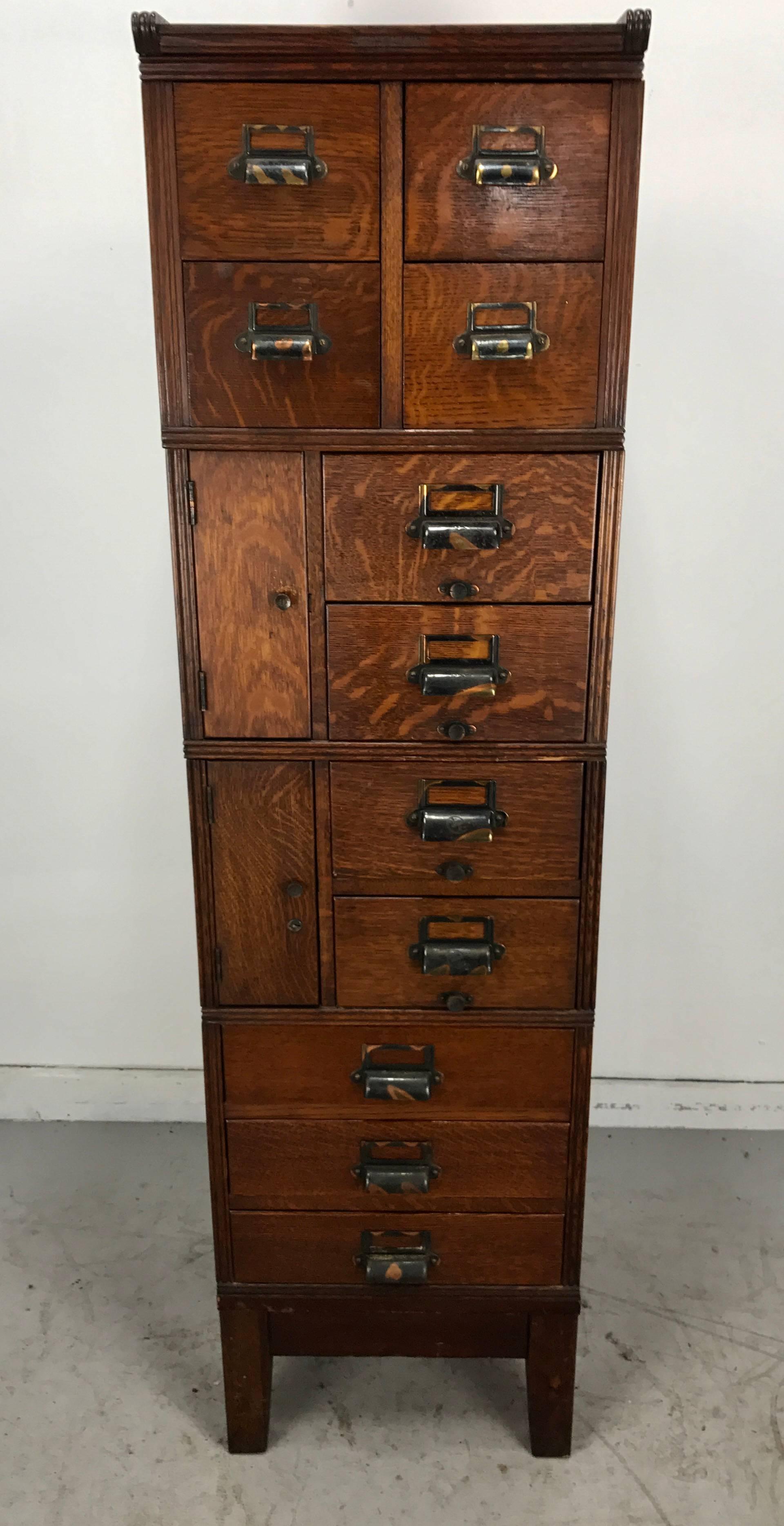 Stunning architectural design, quartered oak stackable file or storage cabinet, by Yawman & Erbe, featuring 13 storage drawers, four stacks enabling versatile configuration, various sizes storage.