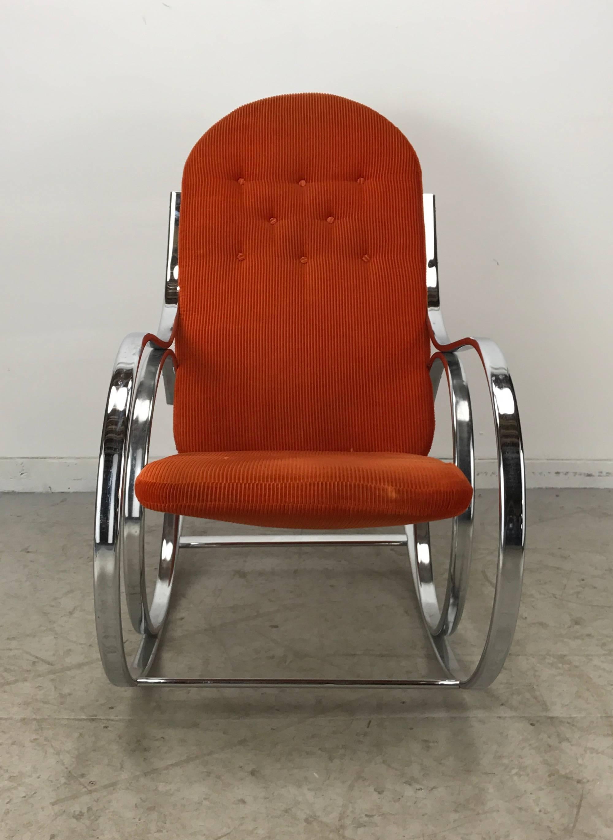 Mid-Century, 1970s rocking chair, chromed Thonet style steel curved frame and button tuft seat and back. Retains original orange cotton fabric, stylish and comfortable,.