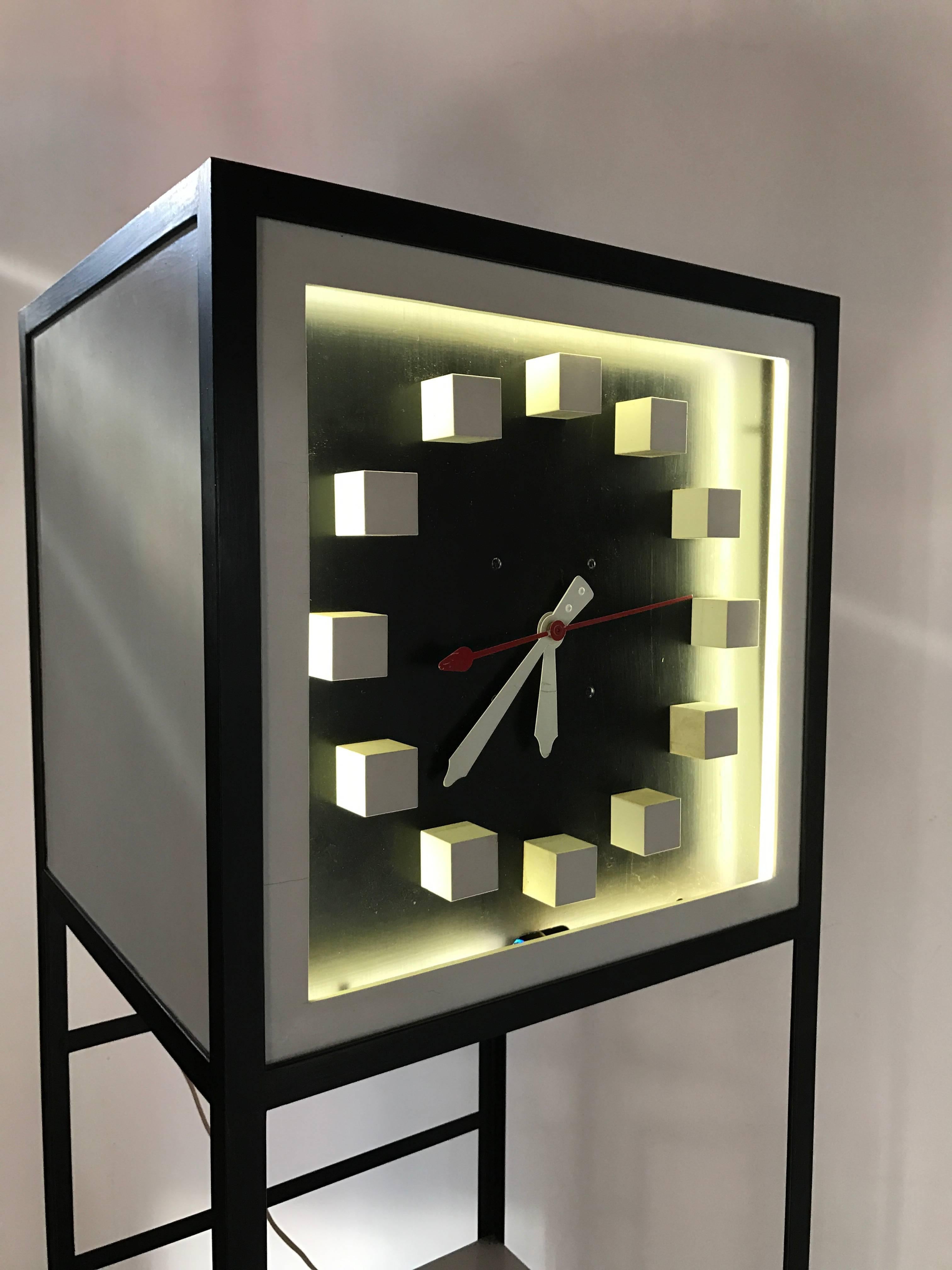 Unusual modernist grandfather clock or shelf, possibly designed by Frederik Weinberg, black iron frame, wood shelves, wood number markers, retains original white neon to illuminate face, amazing architectural design.