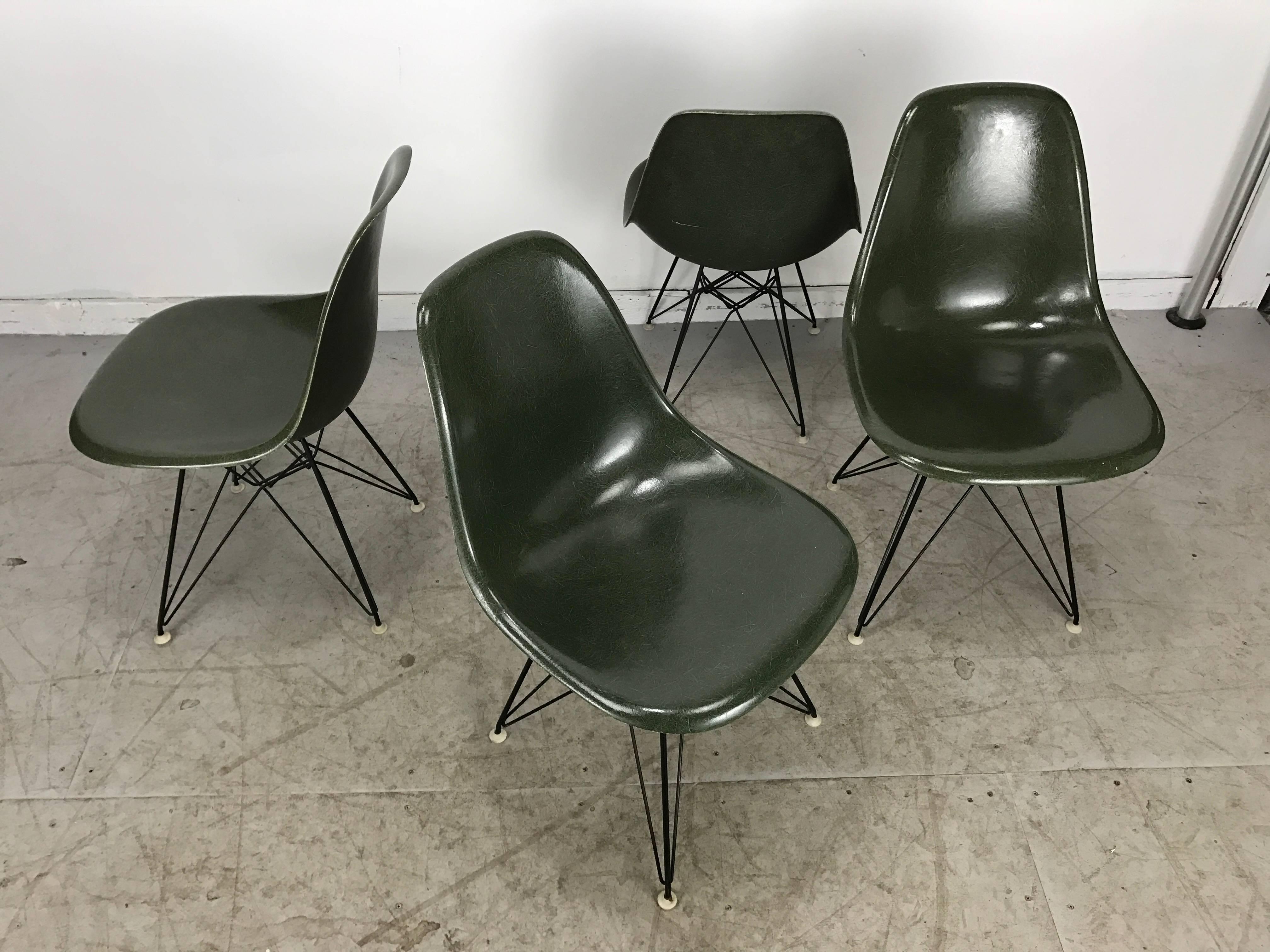 Nice early set of four Eiffel Tower wire base side chairs(scoops) designed by Charles and Ray Eames for Herman Miller, Elusive green color wonderful exposed fibres gel coat. Nice original condition.