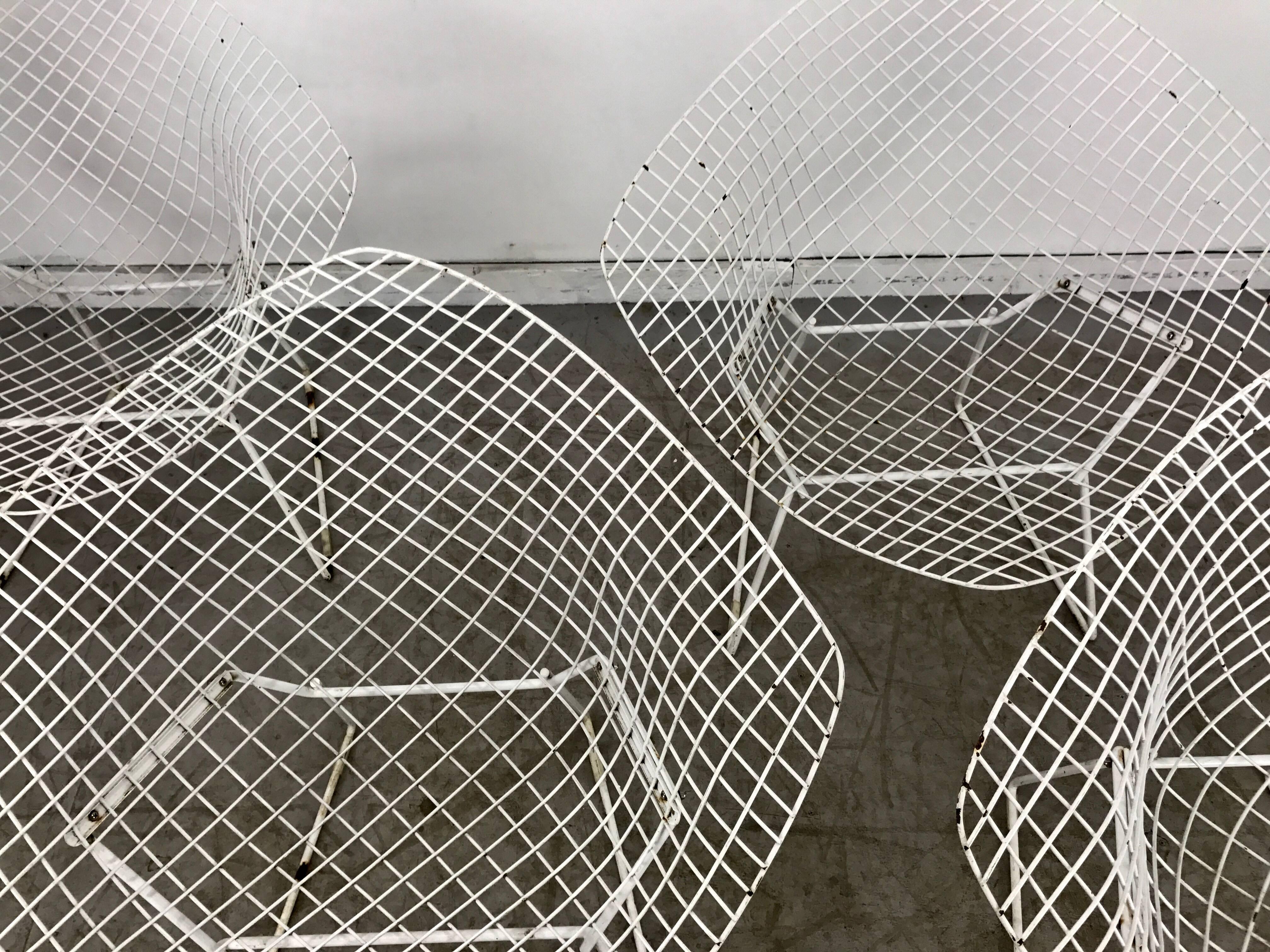 Matching pair of Mid-Century Modern wire 'Diamond' chairs designed by Harry Bertoia manufactured by Knoll. Original finish or patina.