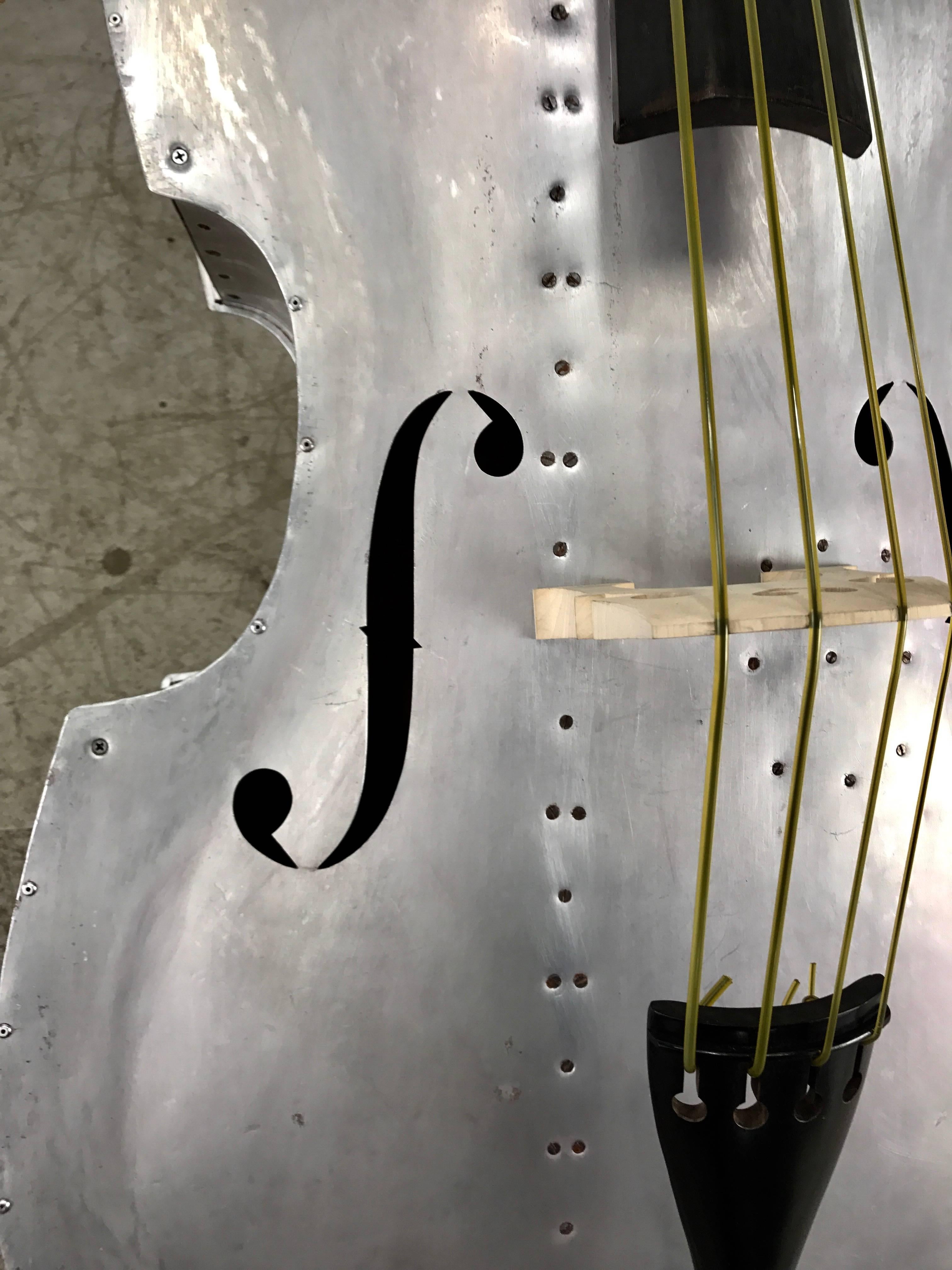 Extremely rare aluminum string bass, circa 1930s, bass was originaly wood grain painted, has been stripped, restrung and set up, new bridge and tail piece, original wood carved headstock missing scroll original ebony fret board, Sounds amazing. If