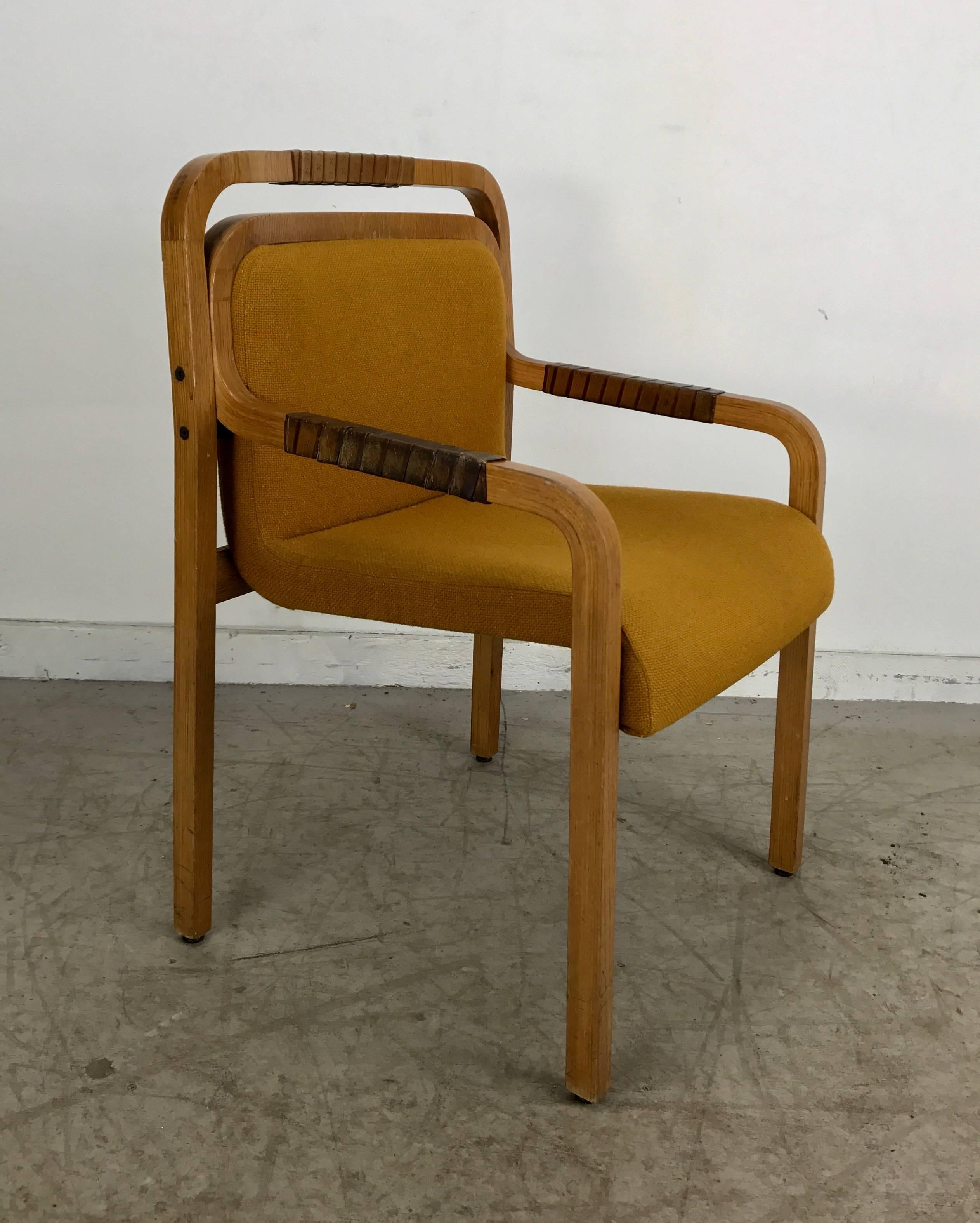Unusual modernist arm or desk chair made by Gunlock. Extremely comfortable, solid sturdy construction, Architectural profile. Retains original leather wrapped arms and back detailing as well as original wool fabric upholstery.