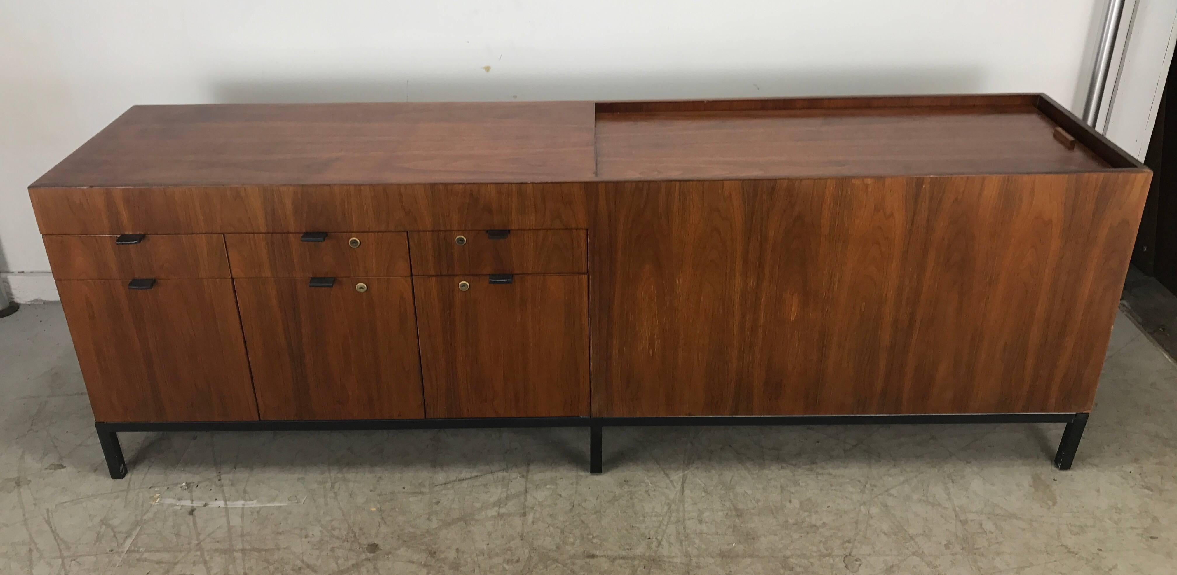 Wonderful walnut credenza or sideboard file manufactured by Stow and Davis in the manner or Florence Knoll handsome bookmatched rich grained walnut with stunning finished back featuring three drawers topping three file drawers and most unusual