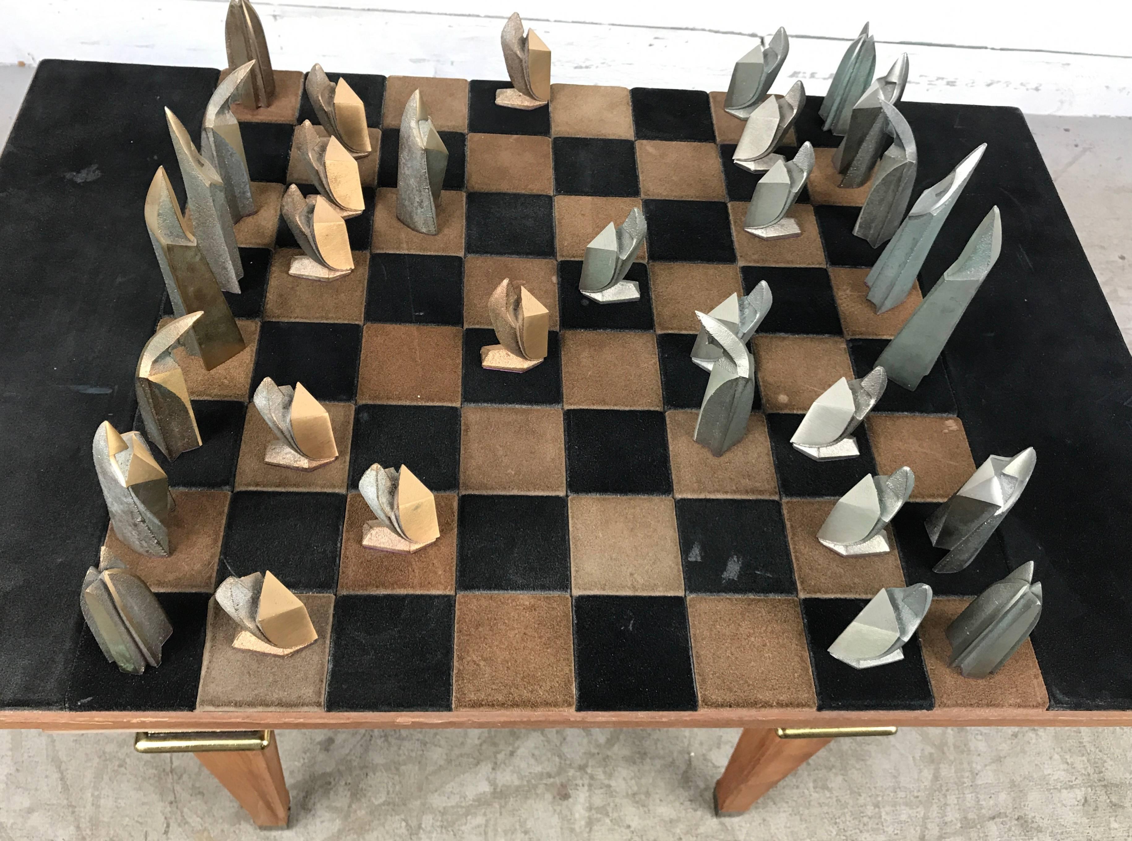 Unusual Modernist Chess Set. Bronze and steel stylized pieces. Cubist. Art Deco. Retains original suede wrapped board. Origin / maker unknown, possibly european