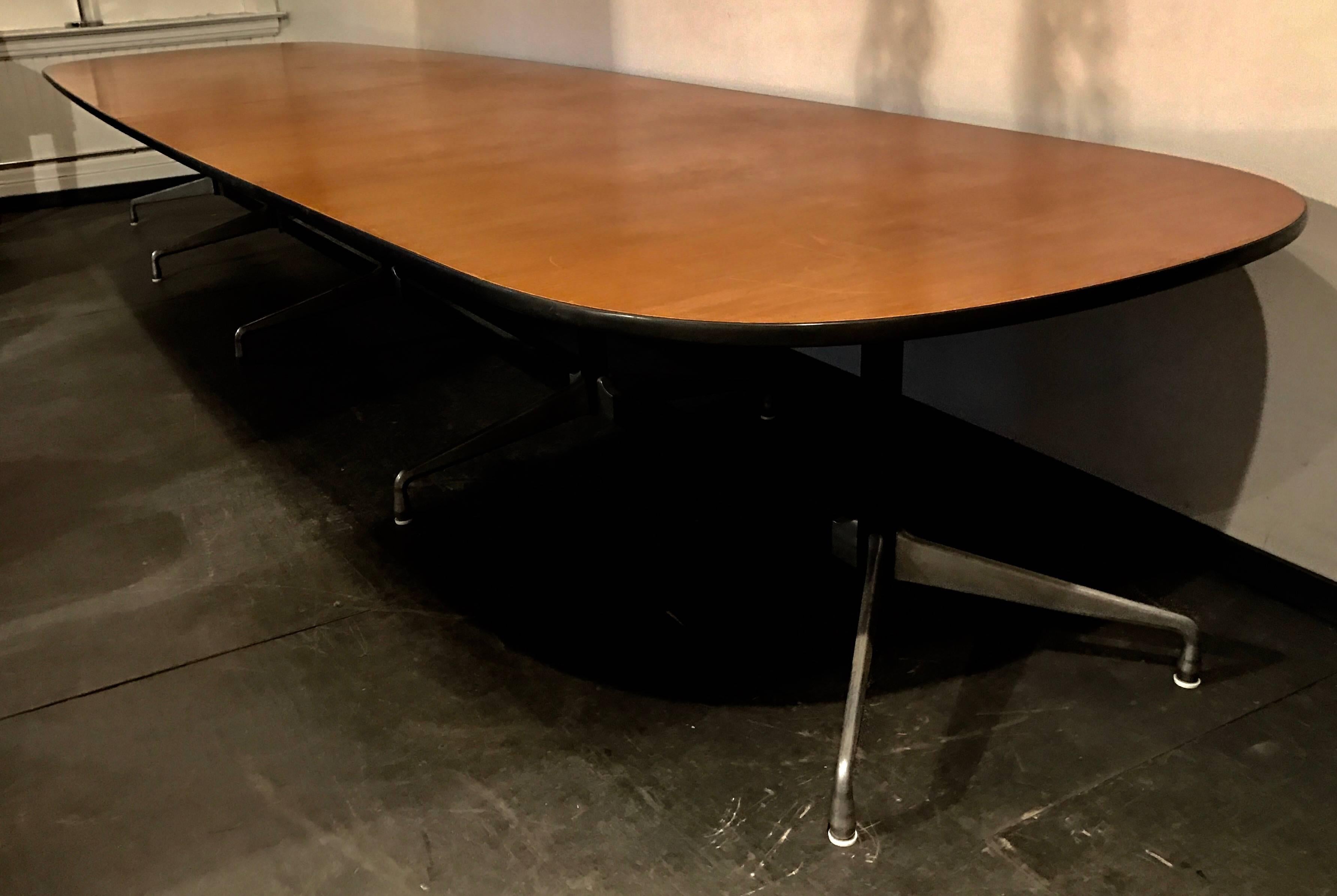 Custom Herman Miller 17' conference table designed by Charles and Ray Eames, walnut wood finish, segmented aluminium group base, White Glove delivery available to New York City.