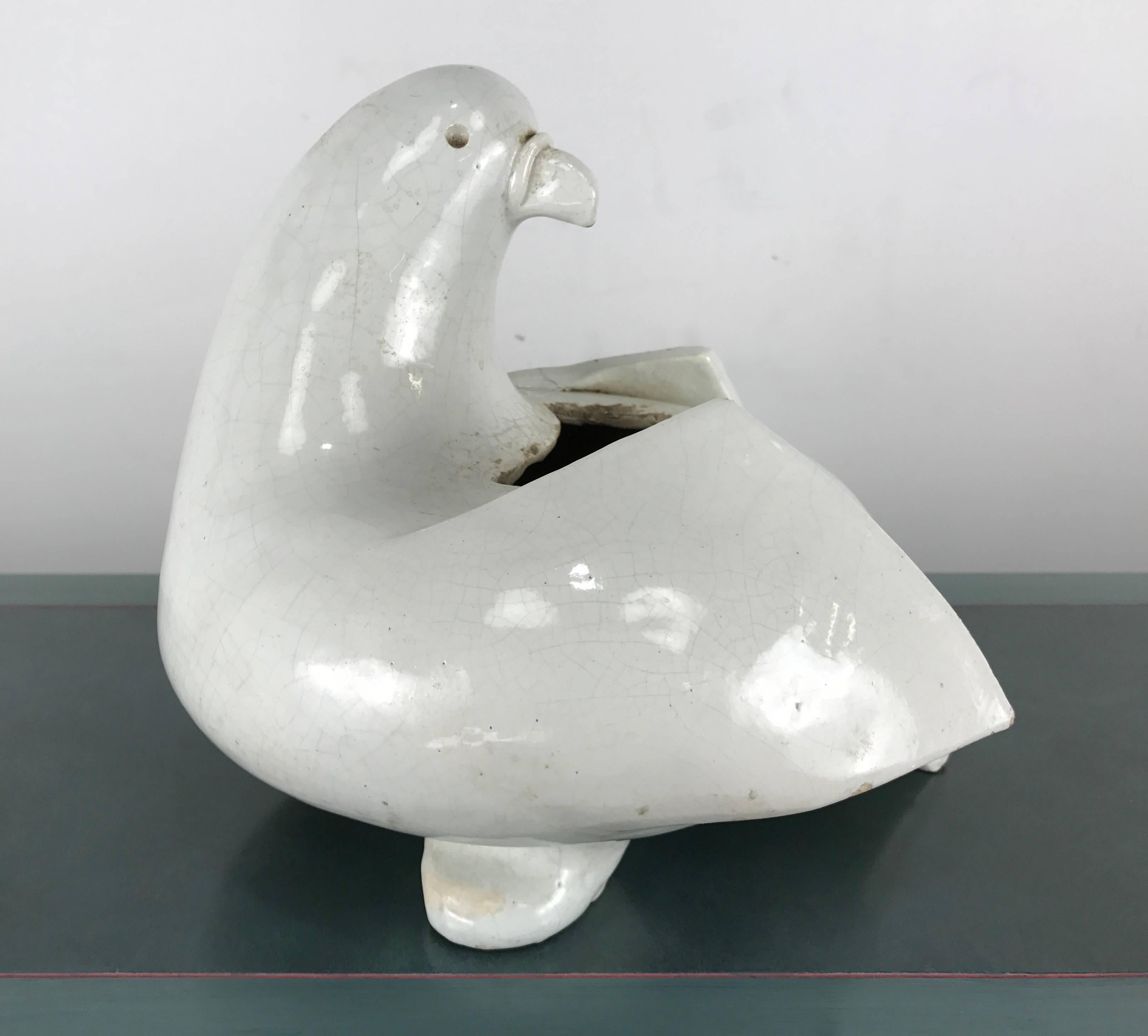 Modernist studio pottery planter or sculpture.

White dove in contemporary stylized design. Beautiful form that combines geometry and fluidity. Smooth texture with wonderful patina and proportion.

Possibly Italian.