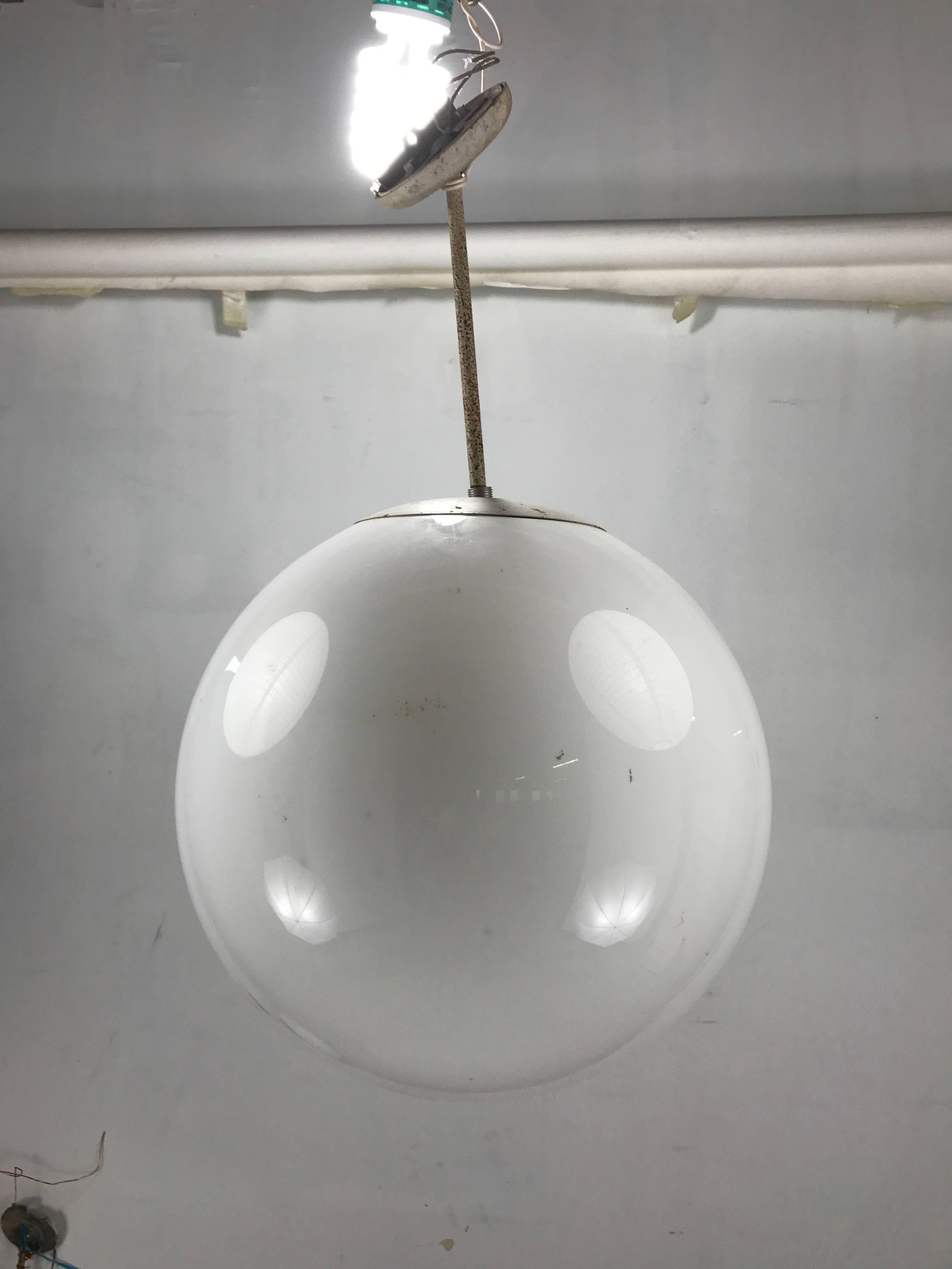 Classic set of opaque white glass globes. Unusual 18-inch diameter. Retain original standards and fitters in need of restoration.