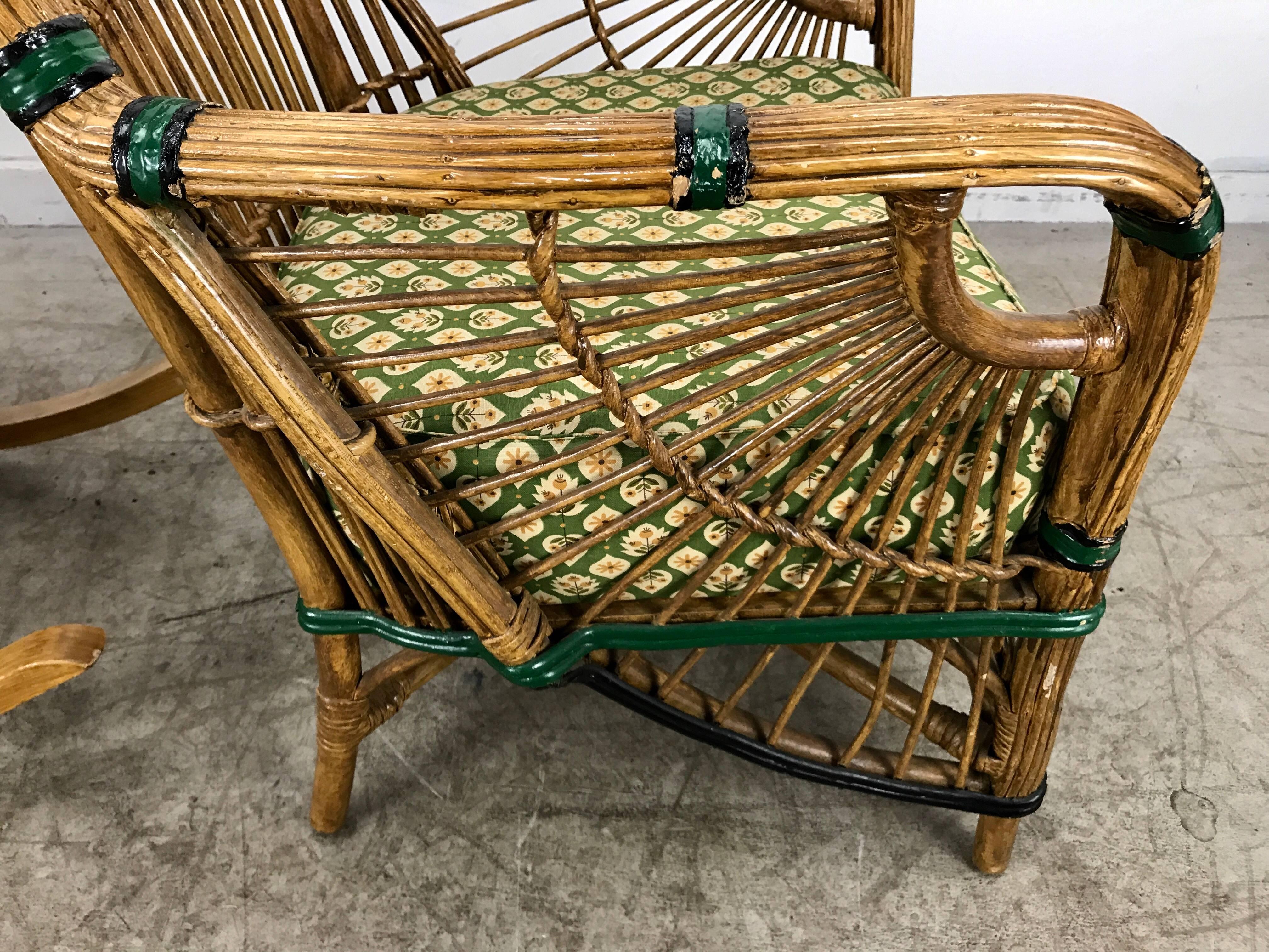 Stunning pair of Art Deco stick wicker/split reed chairs. One stationary, one rocker. Features natural finish with beautiful green and black paint detailing. Also retains original spring cushions, stunning Art Deco 