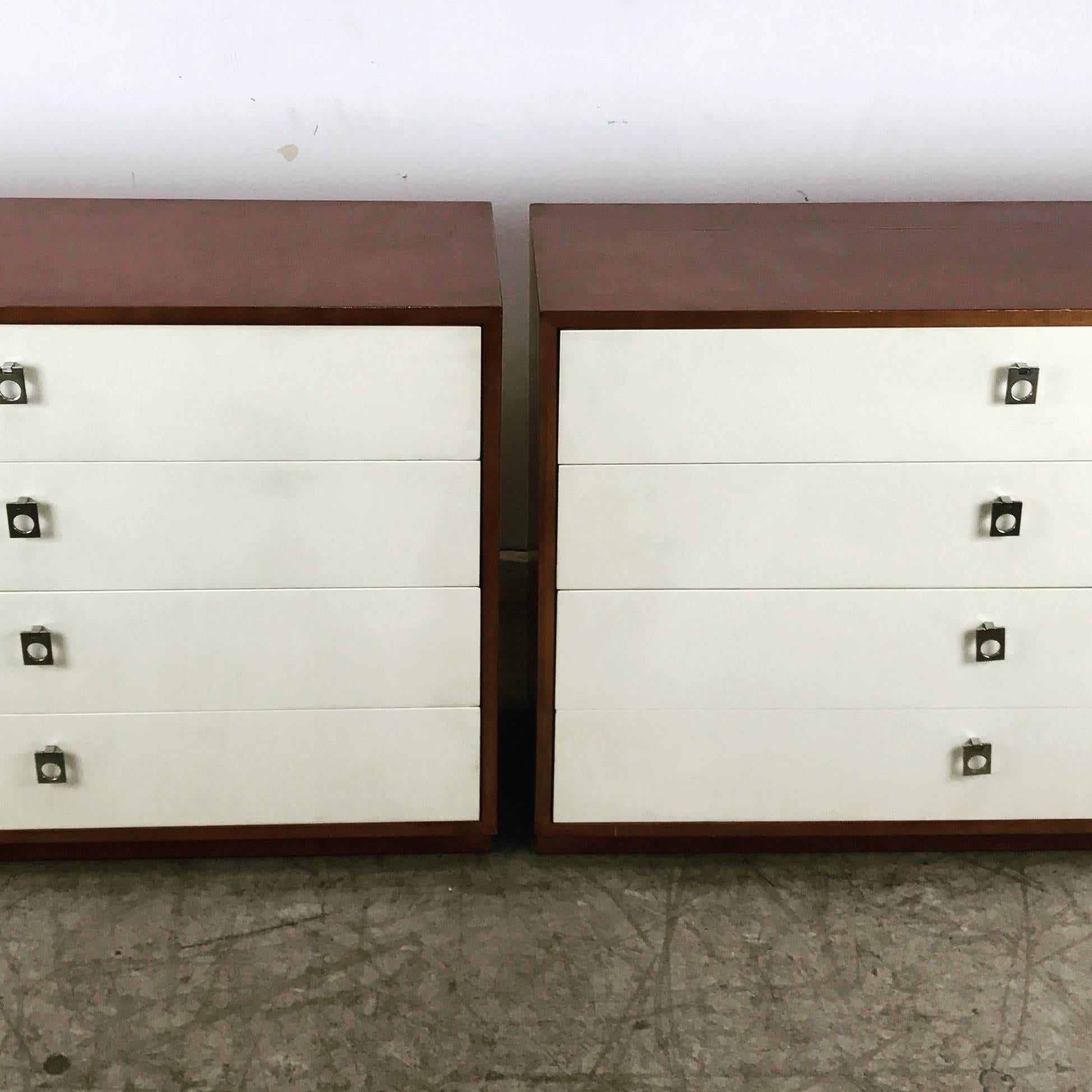 Pair of modernist chests by Jack Cartwright for founders, sleek, simple elegant design featuring four drawer walnut cabinets white lacquered fronts with stylized chrome hand pulls, hand delivery available to City or anywhere en route for Buffalo, NY.