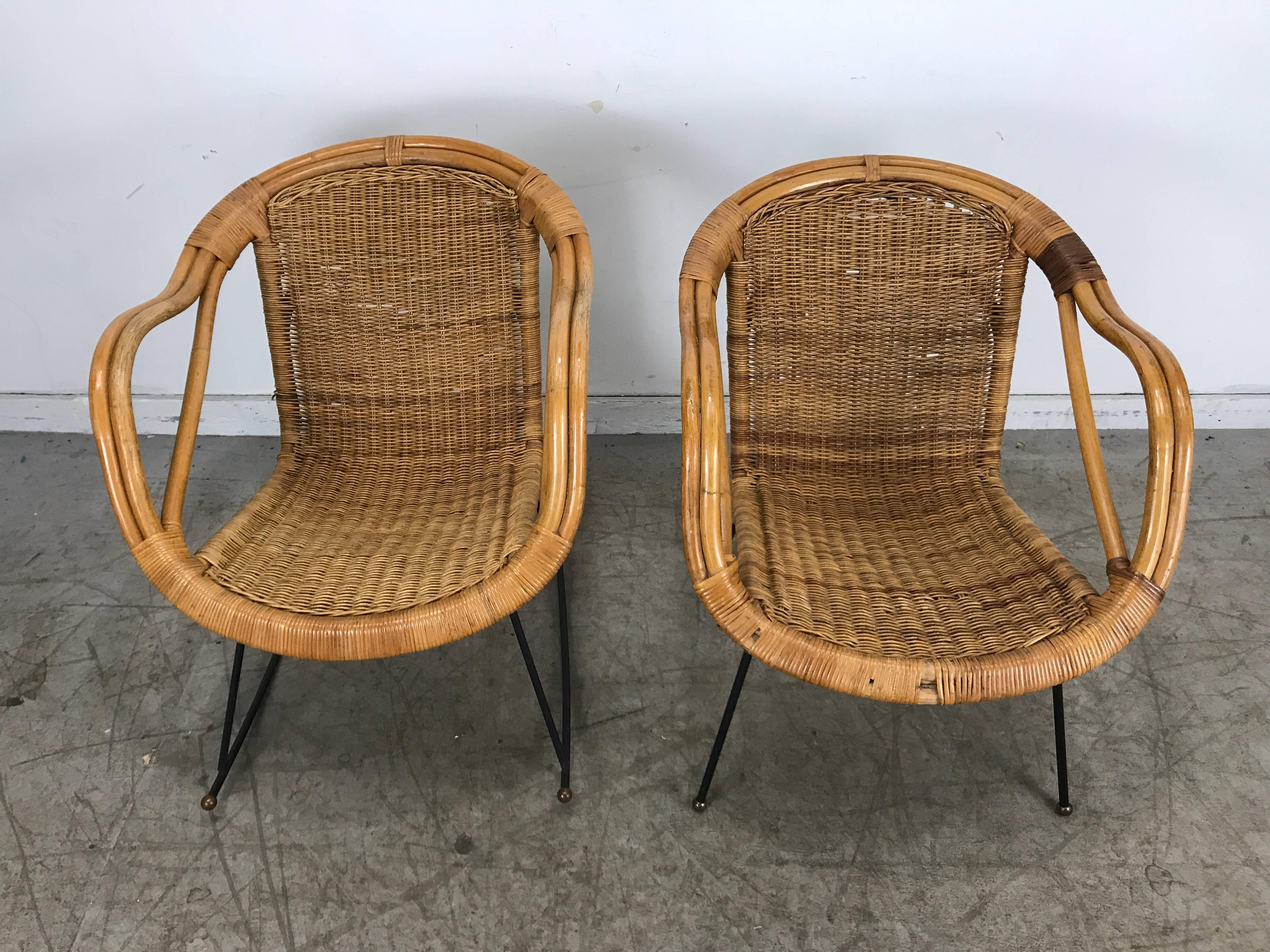 Pair of Mid-Century Modern wicker and iron lounge chairs, garden or patio. Classic modern design, extremely comfortable, structurally sound, sturdy. Hand delivery available to New York City or anywhere en route from Buffalo NY.