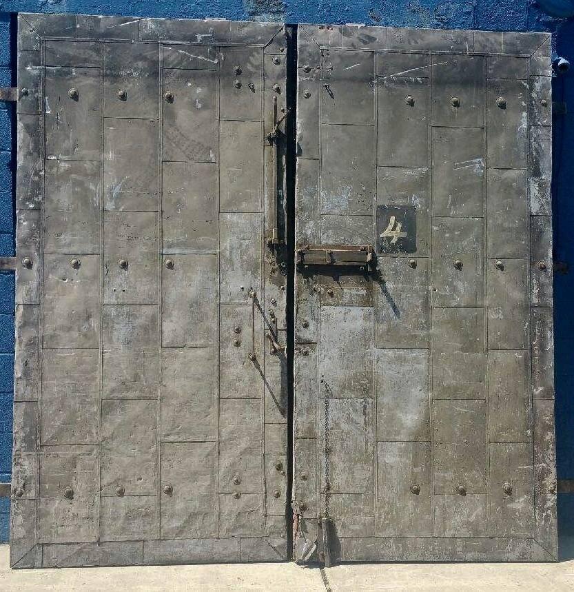 Turn of the century Architectural tin clad fire doors salvaged from factory in Downtown Buffalo New York. Fire retardant, Amazing patina. Solid wood core, retains all original hardware and hinges, hand delivery available to New York City on anywhere