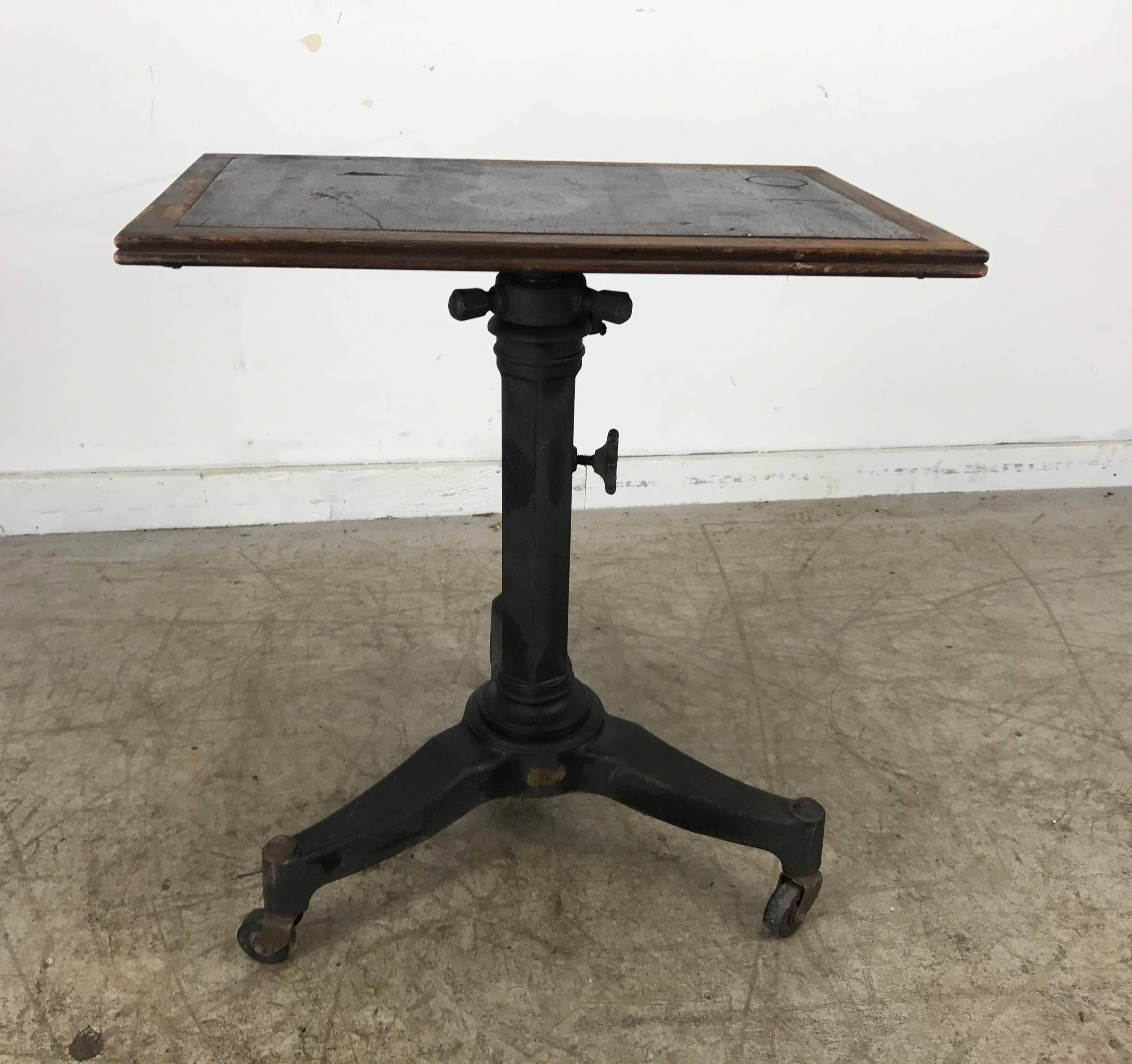 Telescopic cast iron and wood table/stand. Karl Manufacturing Co. Strong, simple architectural design. Classic 1920s cast iron base, locks in place measuring 25 inch high to 38 inch high.