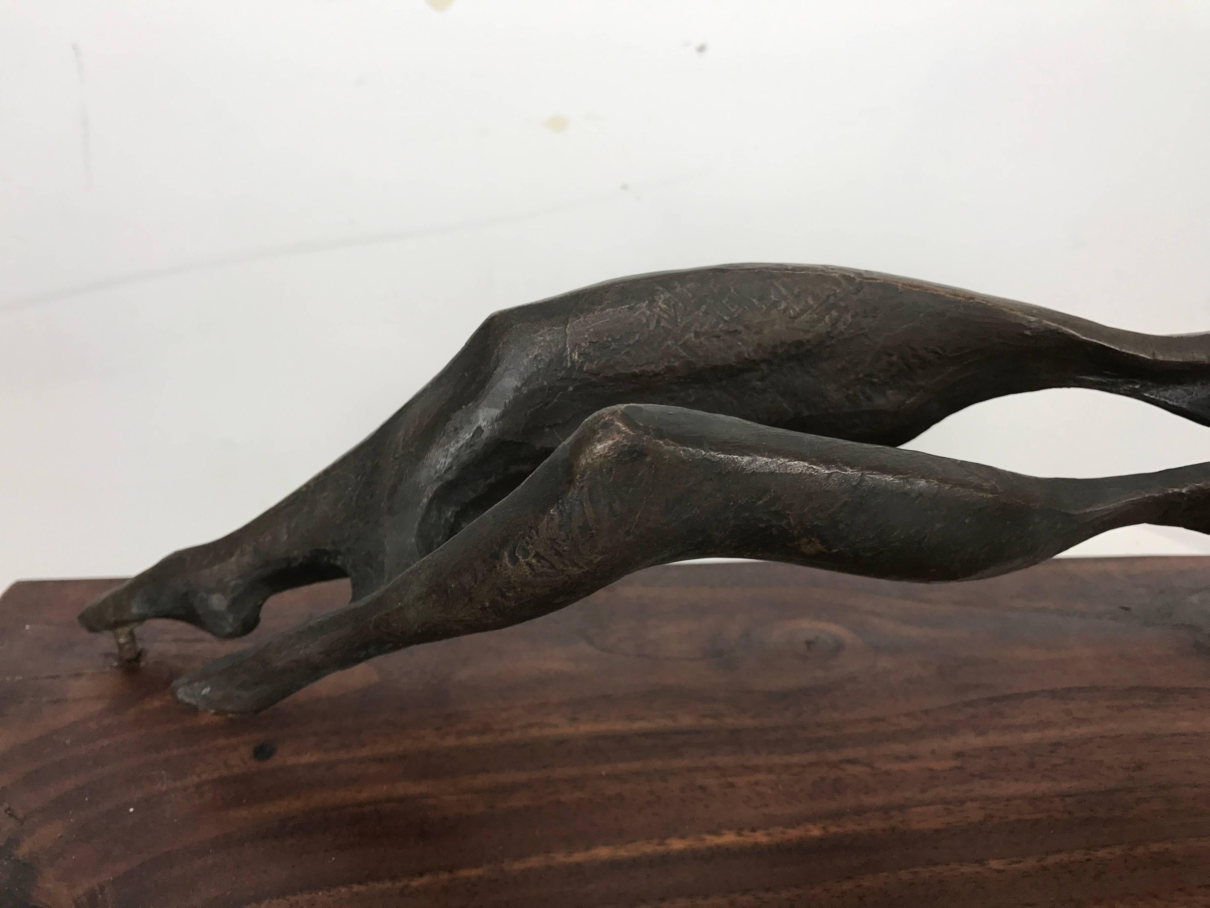 Abstract bronze-mounted in floating fashion on wood. 

Reclining nude with undulating lines adding to the fluidity of the piece. 

Acquired from the private collection of professor of anthropology at University of Buffalo who was an art scholar