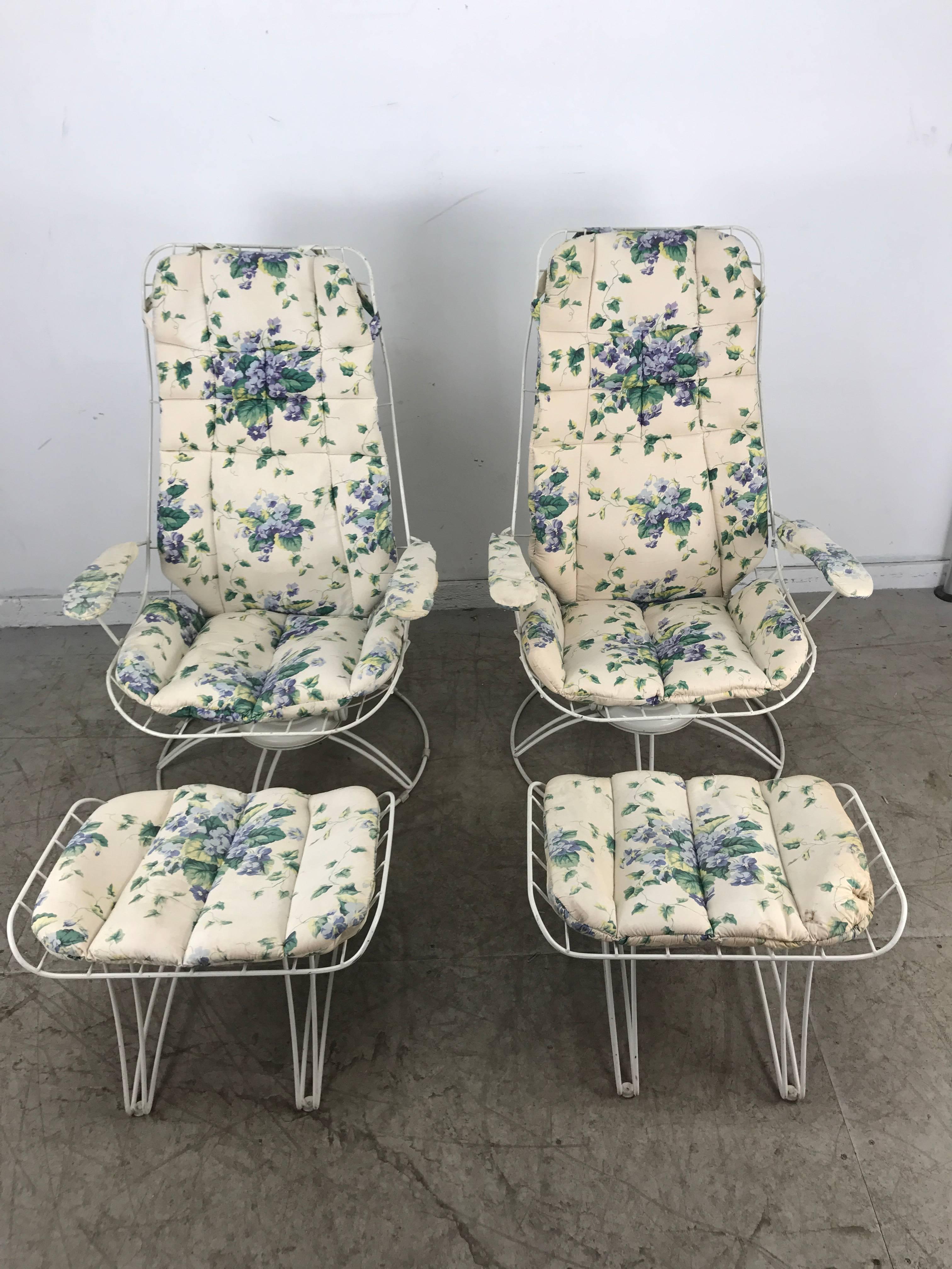 Pair of Mid-Century Modern iron tilt swivel lounge garden chairs and ottomans manufactured by Homecrest Furniture. Classic modernist design. Four of a large group of eight pieces being offered, (see other listings) original replacement cushions