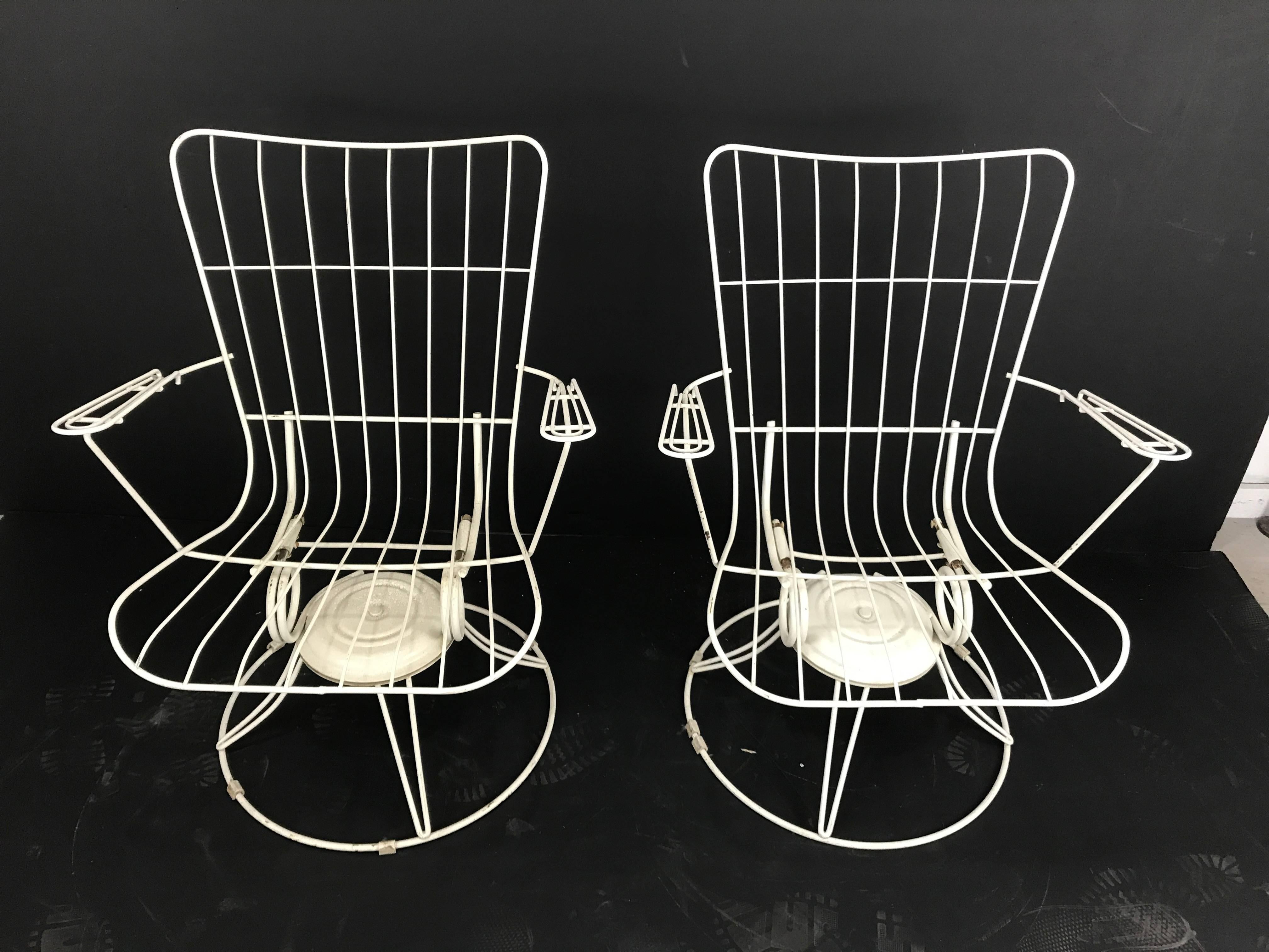 Pair of Mid-Century Modern iron tilt swivel sculptural garden chairs, manufactured by home crest furniture. Classic modernist design. Two of a large group of eight pieces being offered, (see other listings) original replacement cushions available