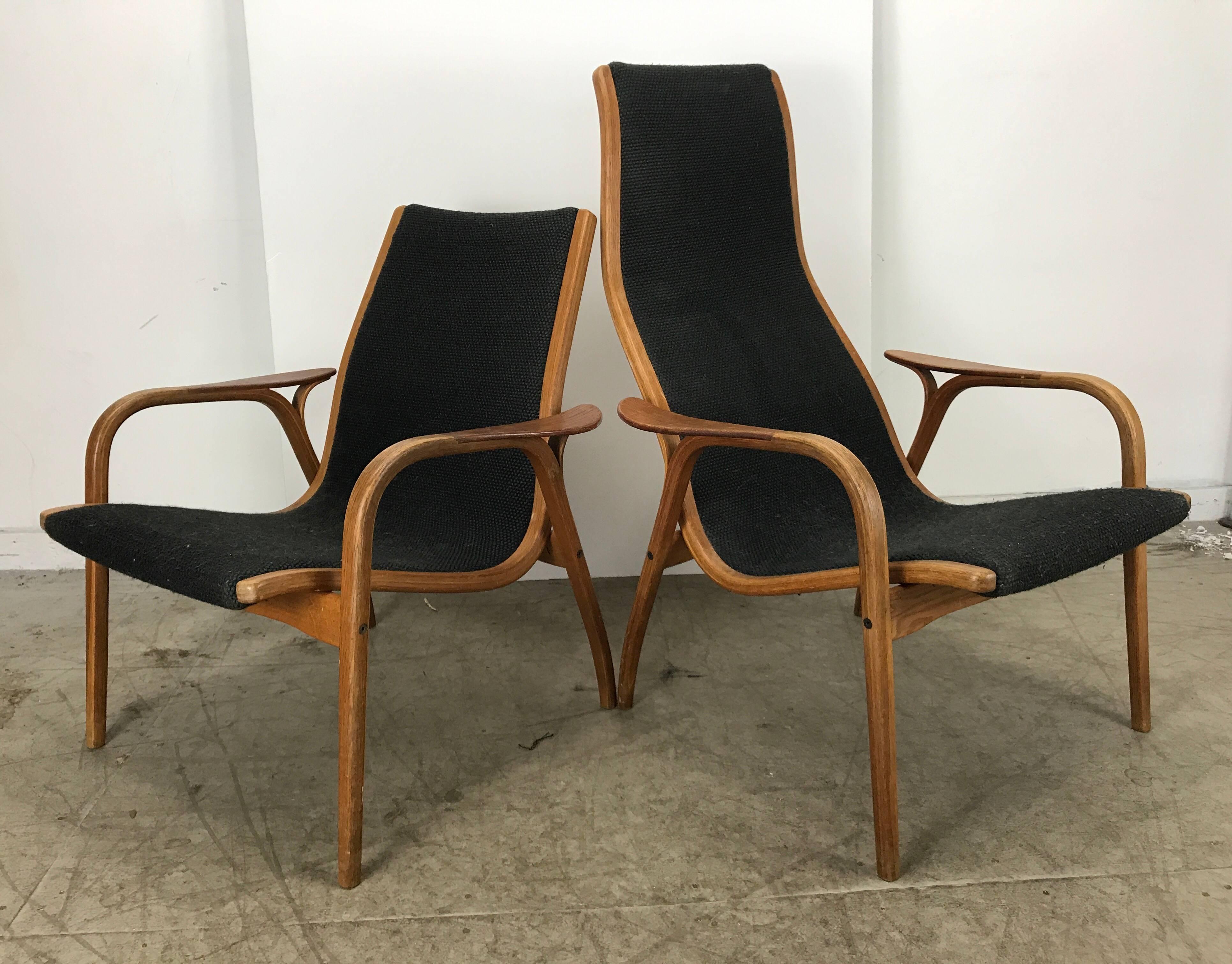 Sleek and stylish His and Hers Scandinavian modern Lamino chair and ottoman designed by Yngve Ekström for Swedese, circa 1960s. The chair features a unique sculptural bentwood design. Using both oak and teak, It is very light weight but sturdy and