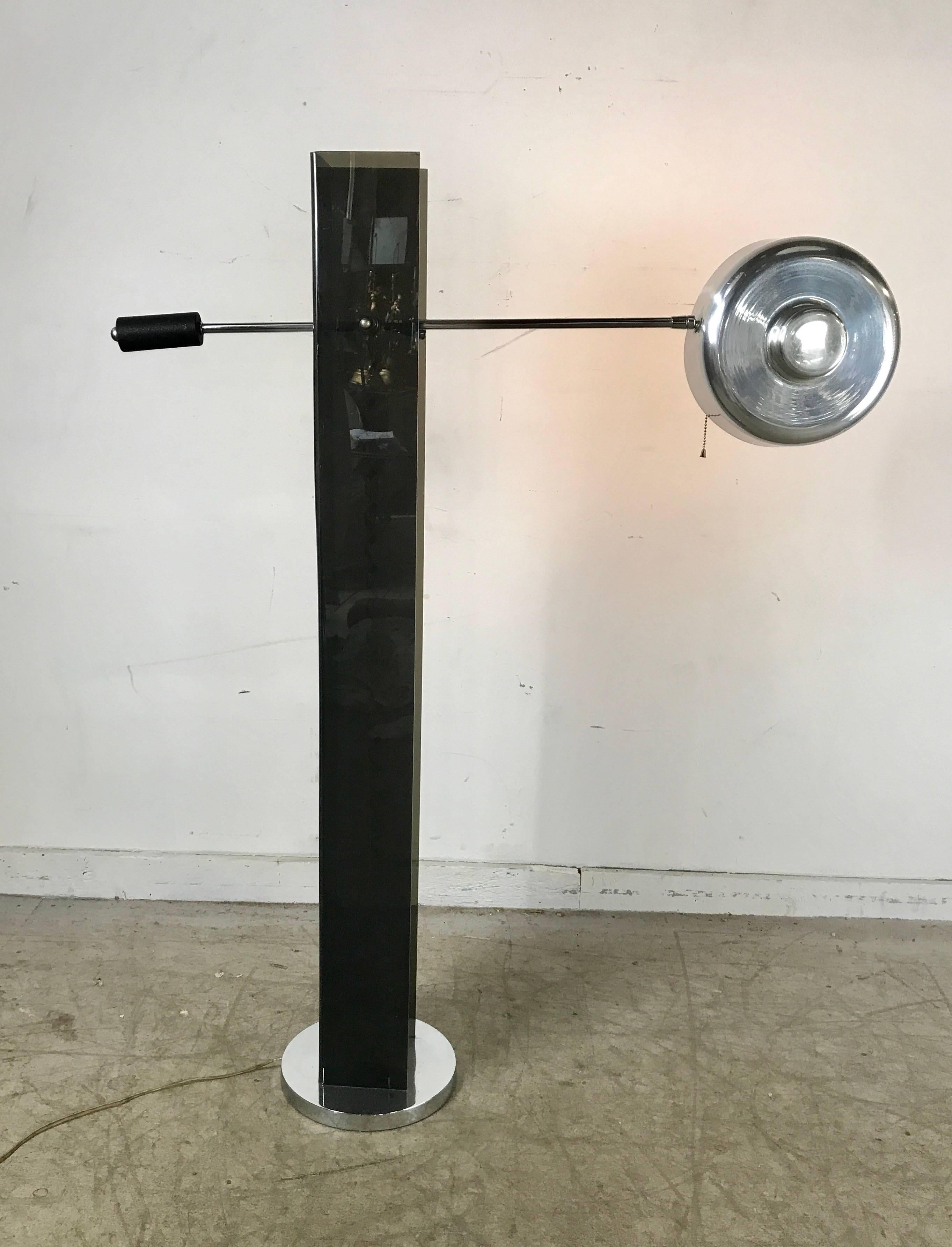 Mid-Century Modern black acrylic and chrome adjustable arm floor lamp. Classic pop 1960s form and design, black acrylic standard with adjustable counter balance arm for multi positioning, original aluminum button shade.