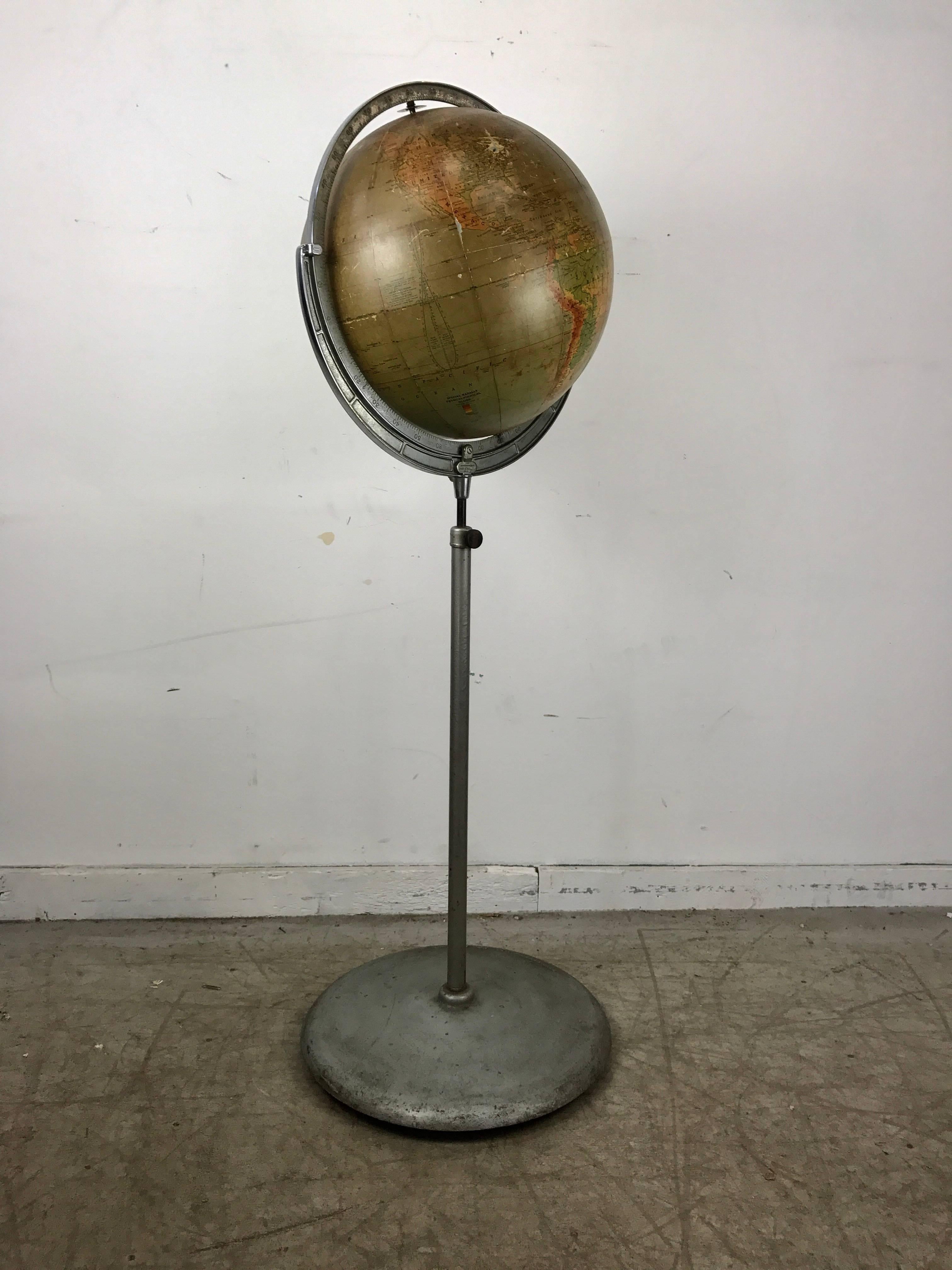 16 inch diameter telescoping adjustable world globe by Rand McNally, Chicago, wonderful color and proportion, adjustable from 52 inches to 76 inches, retains original metal baseball castors for effortless rolling, moving. Minor blemishes and paper