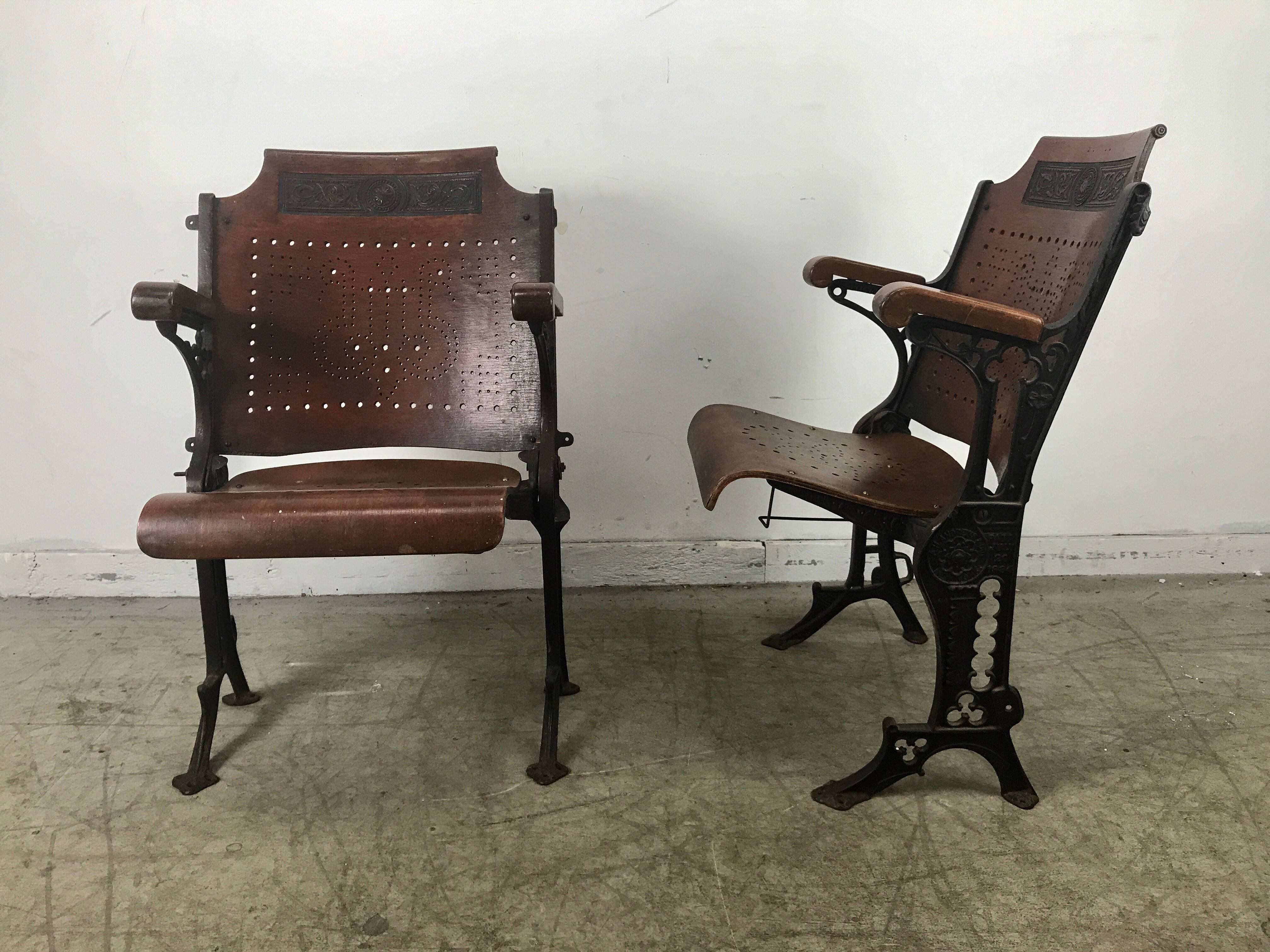 Early cast iron carved and pierced wood theater or opera chairs, A.H. Andrews. New York, circa 1886. Charming! Retain original top hat holder under seat, also designed to hold umbrella or cane.