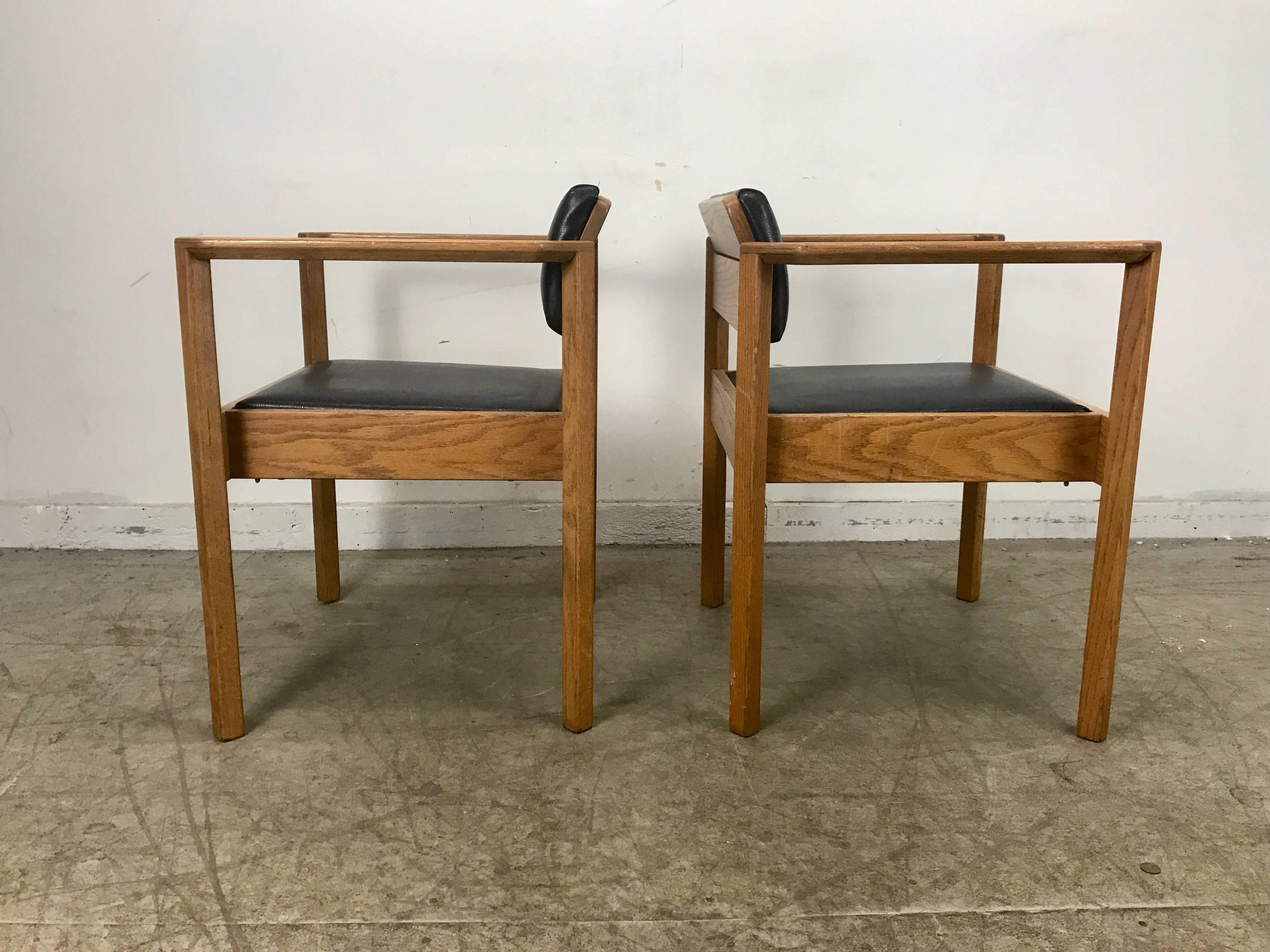 Unusual 1960s sculptural angle arm stacking armchairs, Usonium style, solid rich grained oak construction. Wonderful quality, sturdy, no wobble, Amazing style and design, recently re upholstered in slightly textured naugahyde, extremely comfortable,