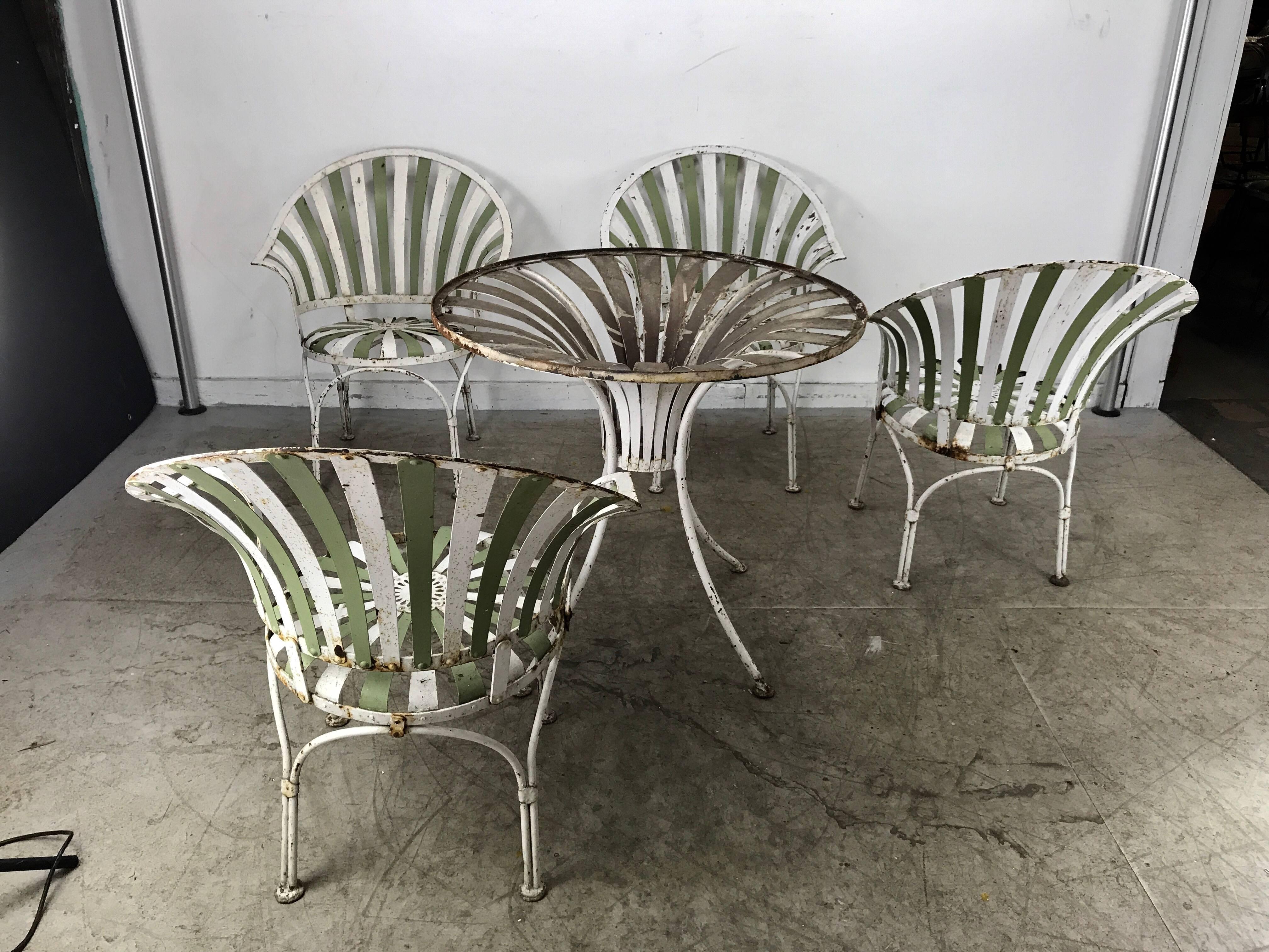 1930s Art Deco metal fan back garden set, table and chairs by Francois Carre. Consisting of four fan back armchairs and table base, in as found condition, some rust but no breaks or re welds, chairs measure 32 in. H x 24.5 in. W x 26 in. D,, hand