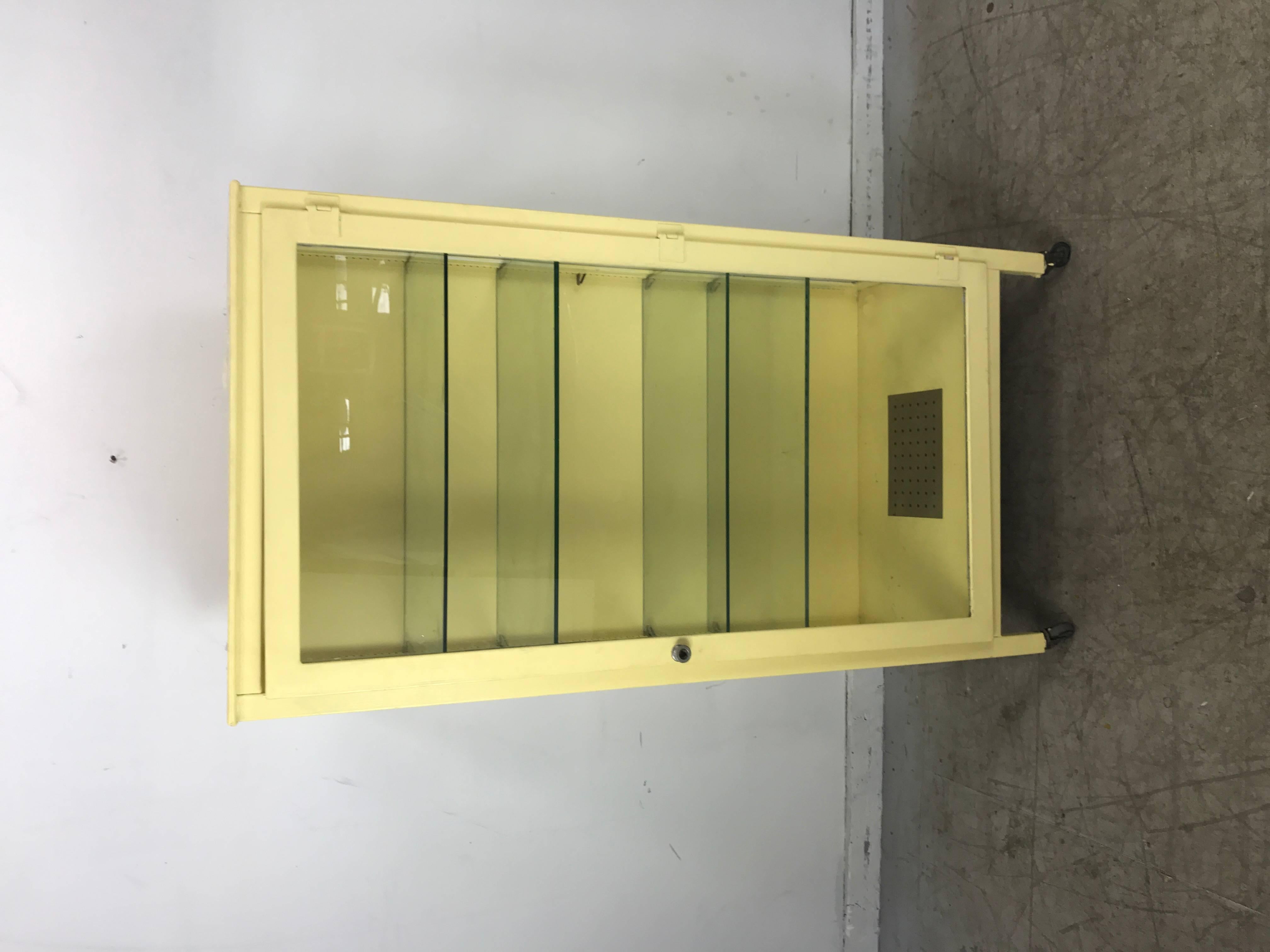 Classic Industrial metal and glass cabinet. Painted steel with large door and four interior glass adjustable shelves, hand delivery avail to New York City or anywhere en route from Buffalo New York.