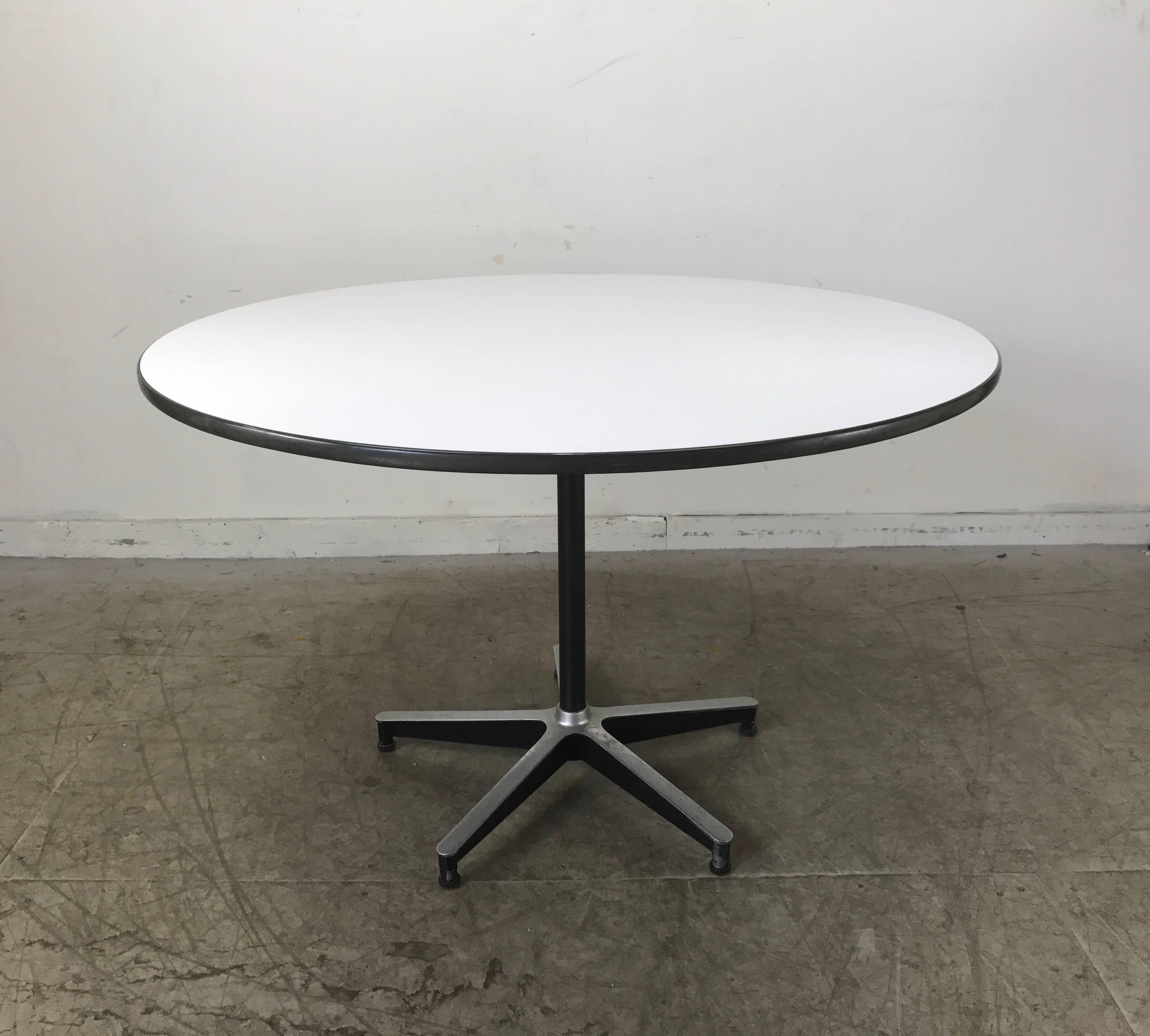 Classic Dinette or dining room set designed by Charles and Ray Eames manufactured by Herman Miller. Set includes white laminate table with five star aluminum base. Set of four fiberglass side shell chairs with original swivel four star alumimum
