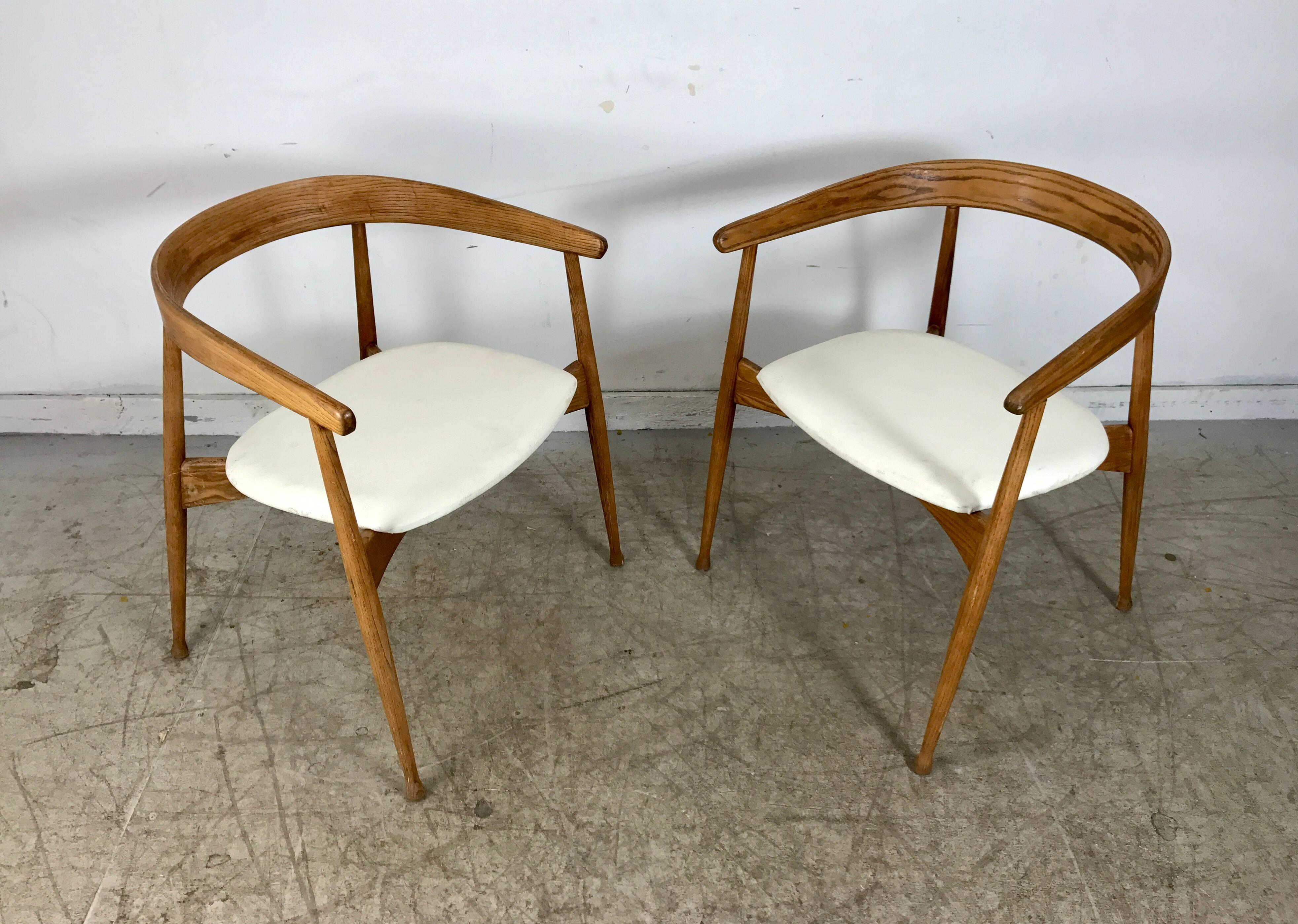 Matched pair of American Danish armchairs in the style of famed Danish designer, Hans Wegner. Sculptural yet elegant design, Classic bent oak construction, extremely comfortable.