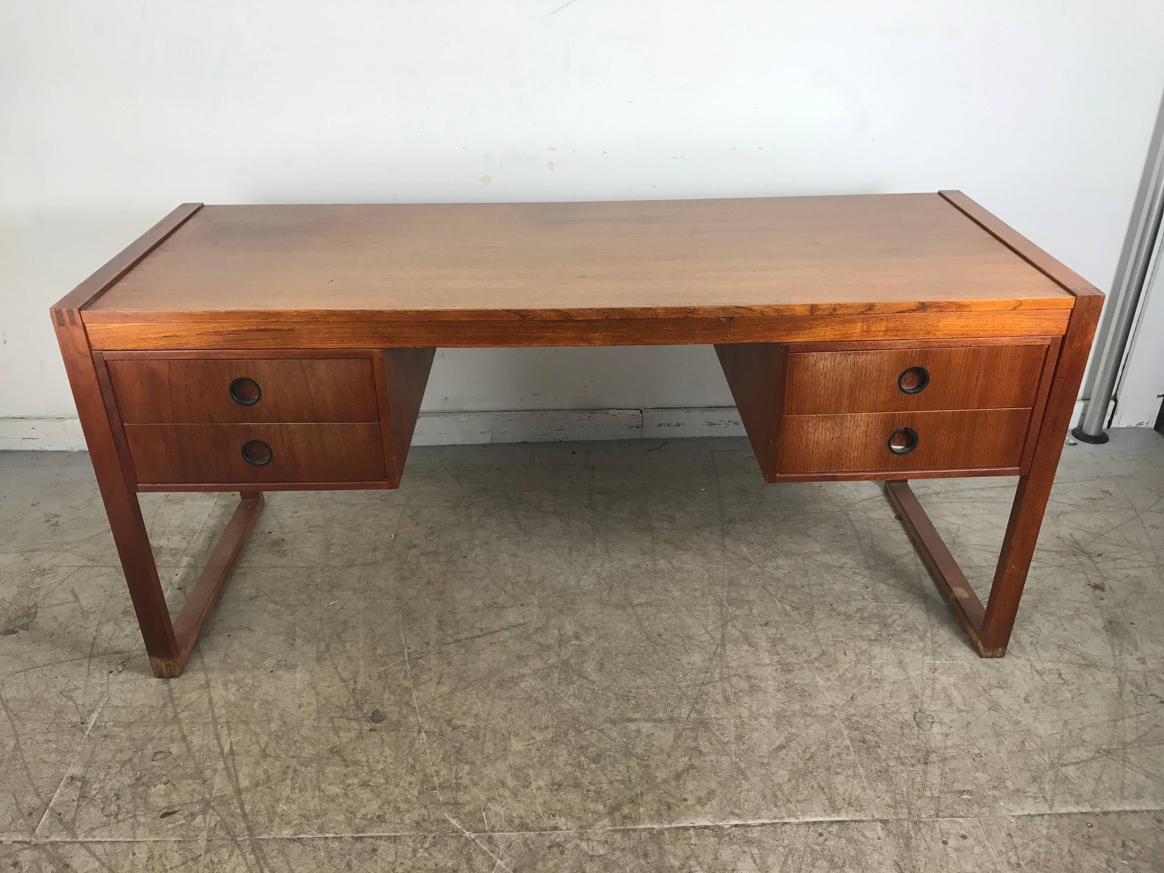 Classic teak desk attributed to Peter Løvig Nielsen for Lovig. Featuring handsome, simple design, two drawers on each side, subtle dovetail corner detailing, a beautiful mid-sized desk for home or office. Hand delivery avail to New York City or