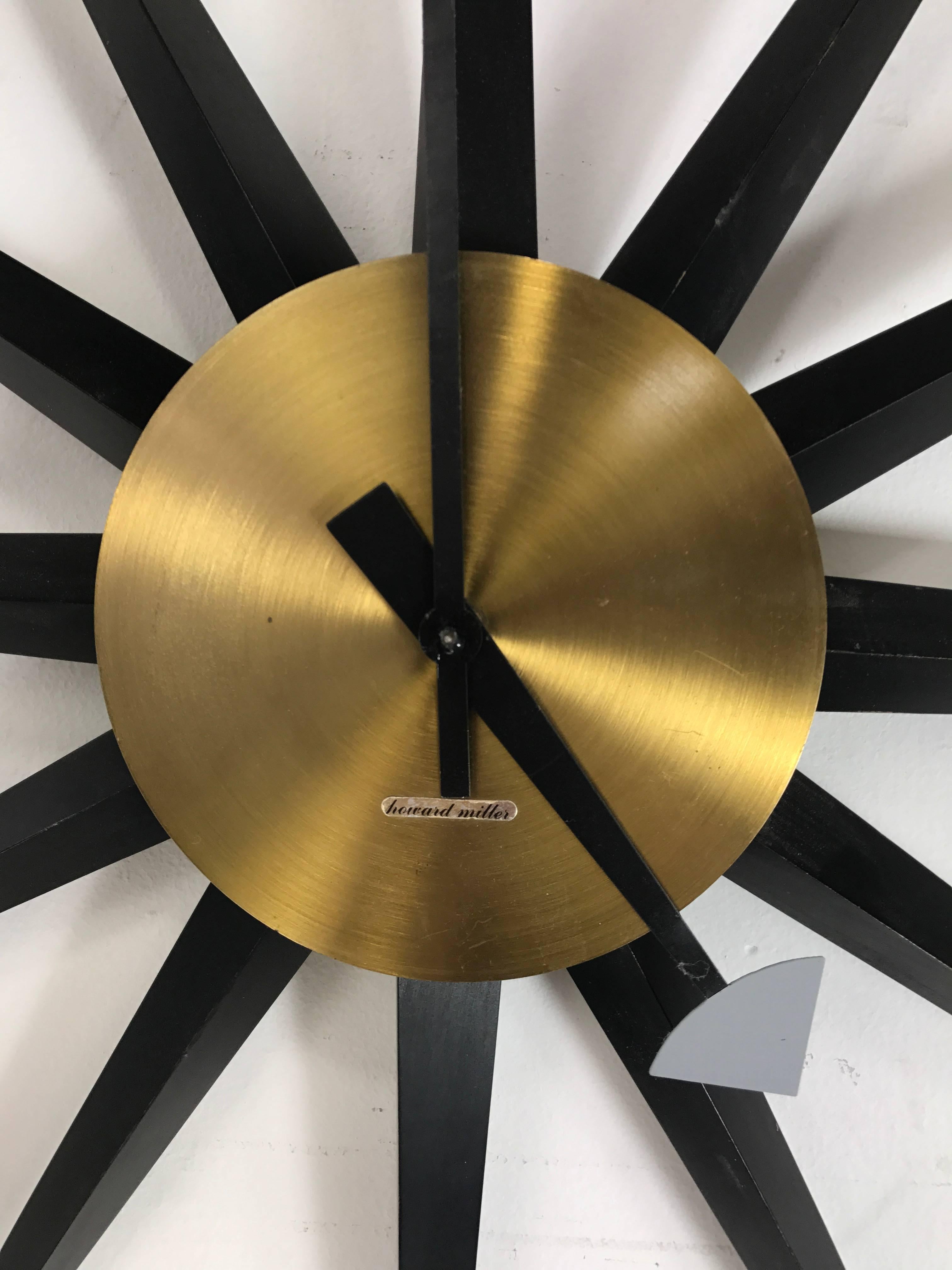 Rare Oversized Mid Century Modern spike clock designed by George Nelson, manufactured by Howard Miller, original pale yellow body, black painted wood spikes, brass face. These clocks primarily hung in corporate offices or department stores, seldom