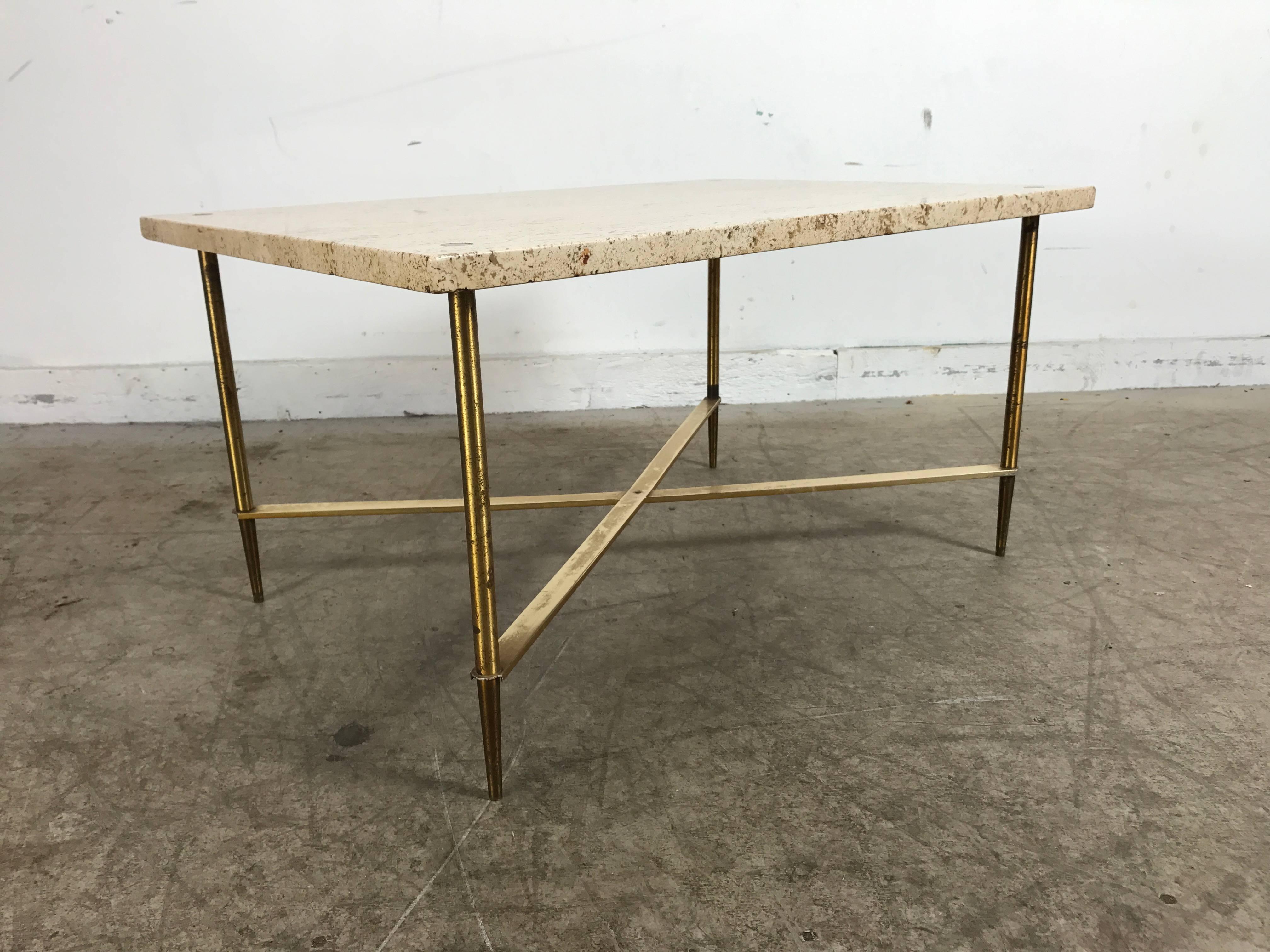 Stunning travertine and brass tables after Gio Ponti made in Italy, classic modernist regency design, solid brass legs and X stretchers, legs dowel thru top. Versatile height and design that allows tables to be used as coffee / cocktail, ends or