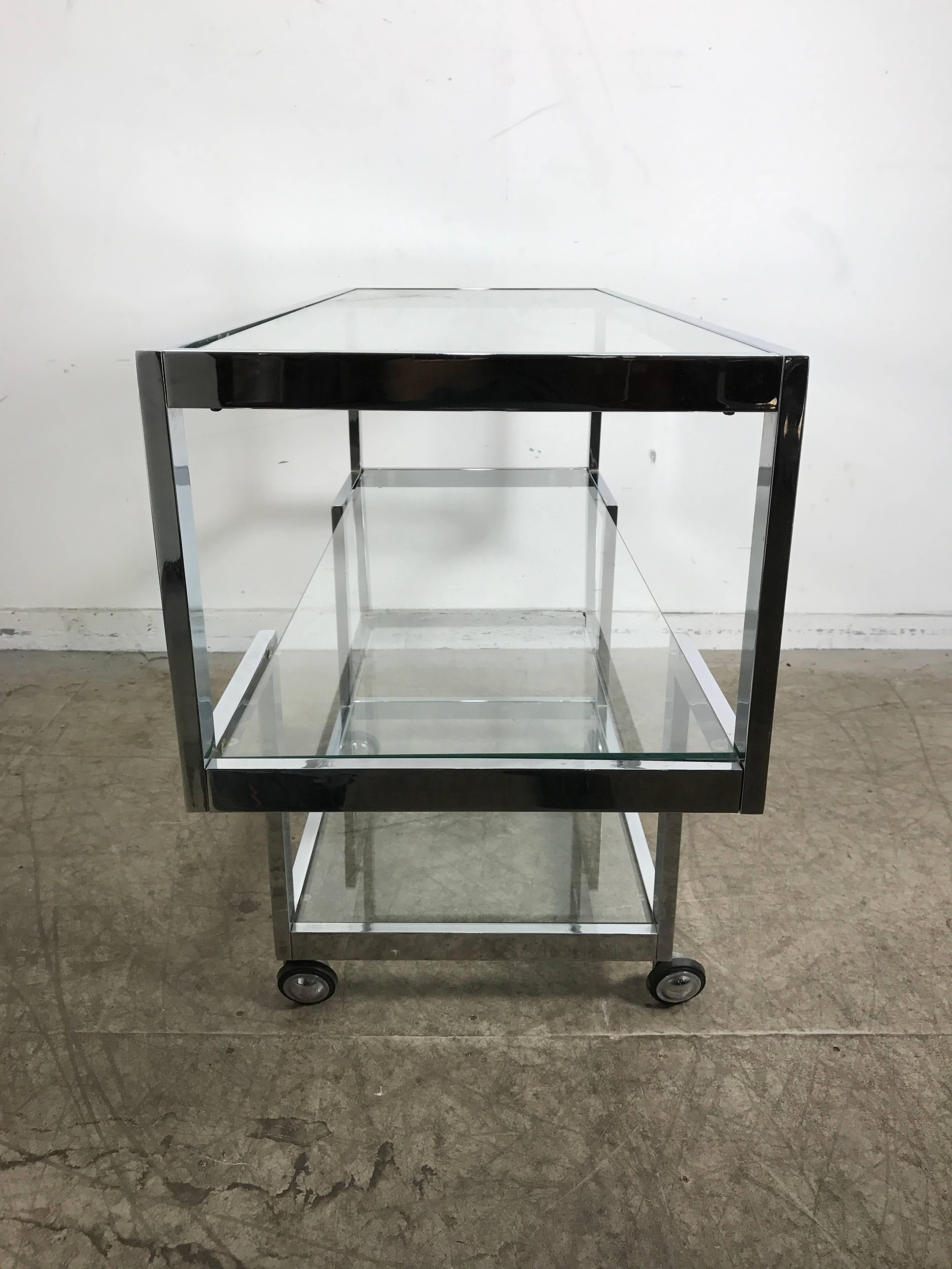 1970s chrome and glass bar cart/ server, handsome architectural design, would also make a stunning console table, designed by Milo Baughman, hand delivery avail to New York City or anywhere en route from Buffalo New York.