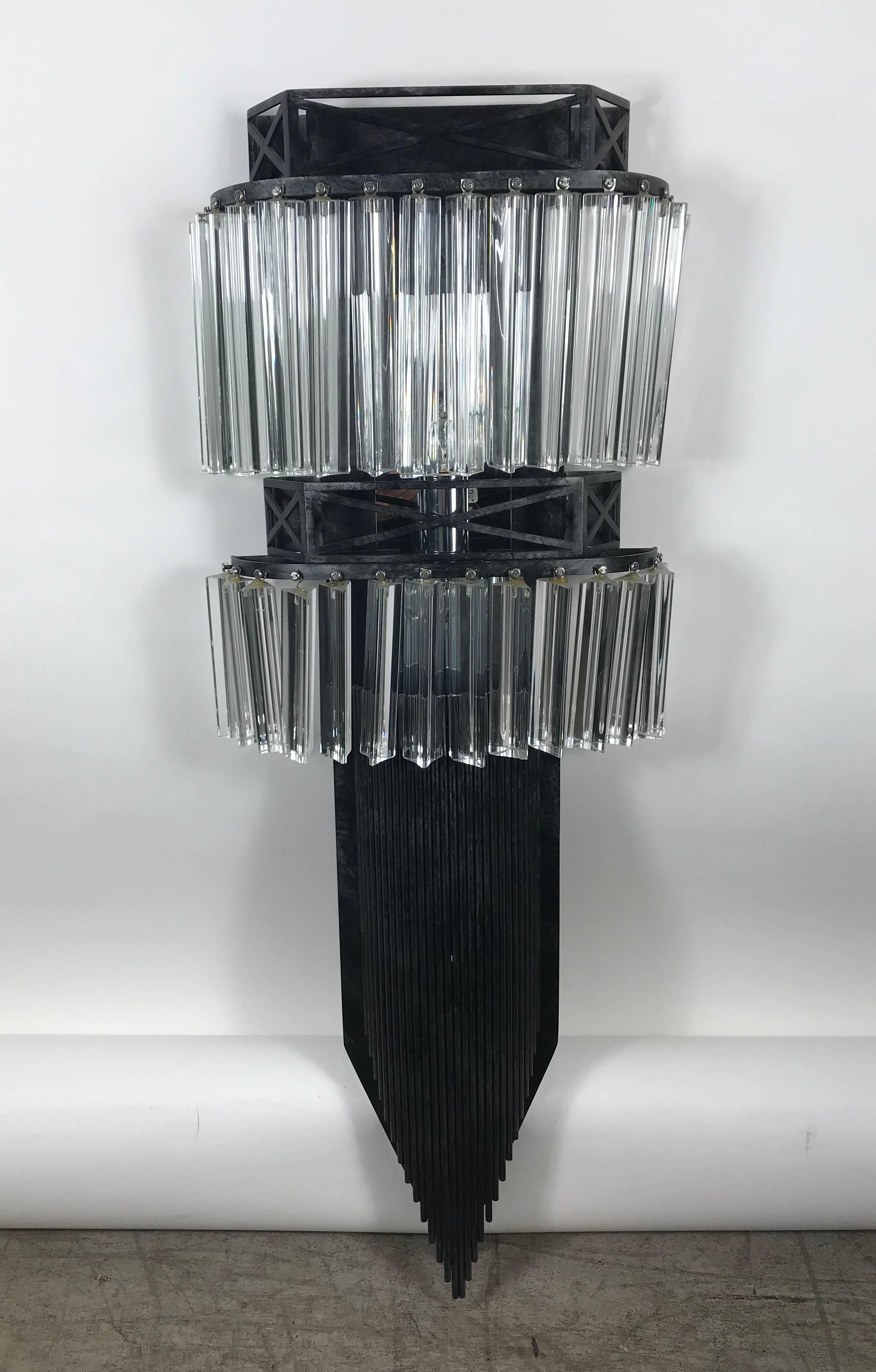 Amazing design! Brutalist meets elegance, set of 12 matching Venini glass and Iron wall sconces, measuring 42 inches high, feature approximate 24 three-sided (triangular) Venini glass hanging crystals, top row measuring 8 inch bottom row 6 inch