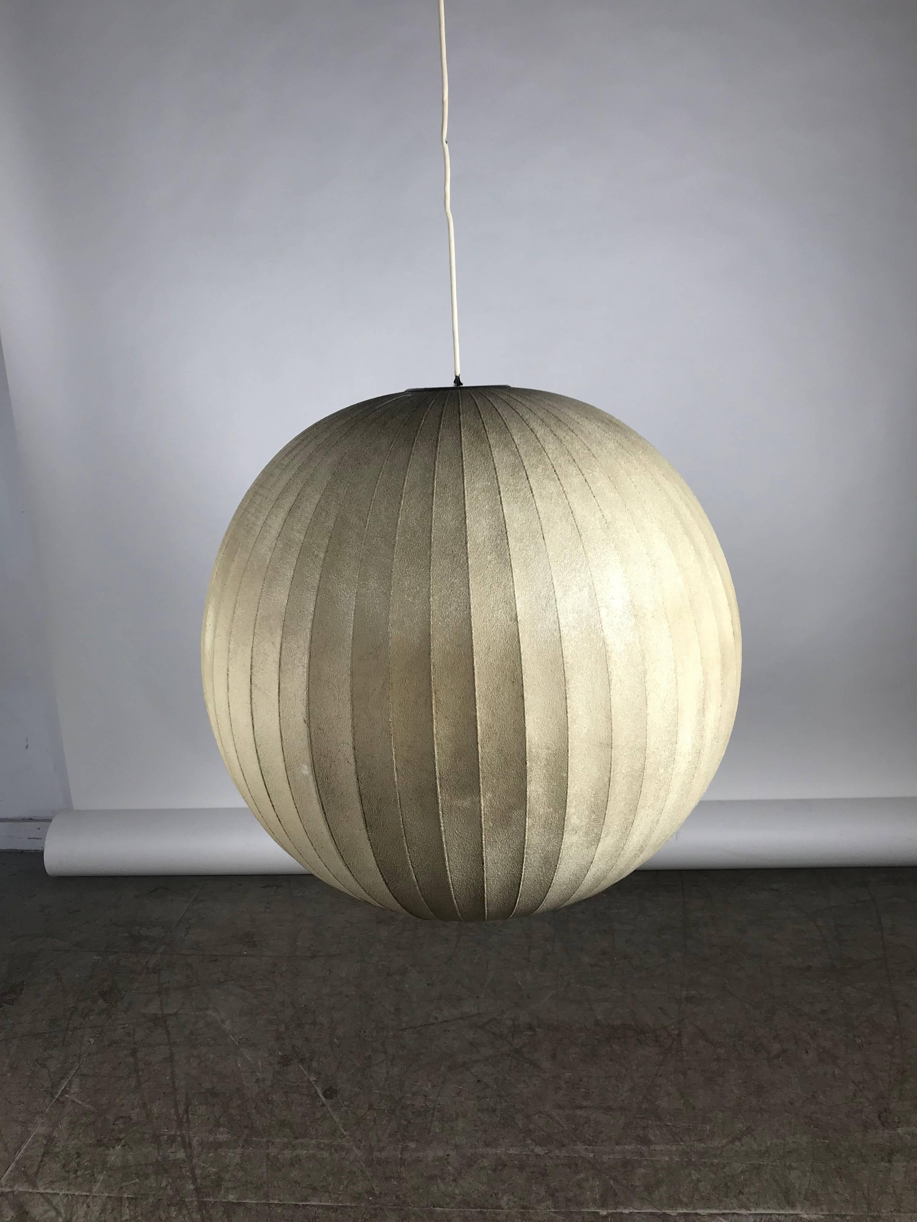 The largest bubble lamp Howard Miller ever produced. Measures: 25 inches in diameter. Not in current production! Designed by George Nelson, very early production, retains original Howard Miller bubble light fixture label, beautiful warm patina when