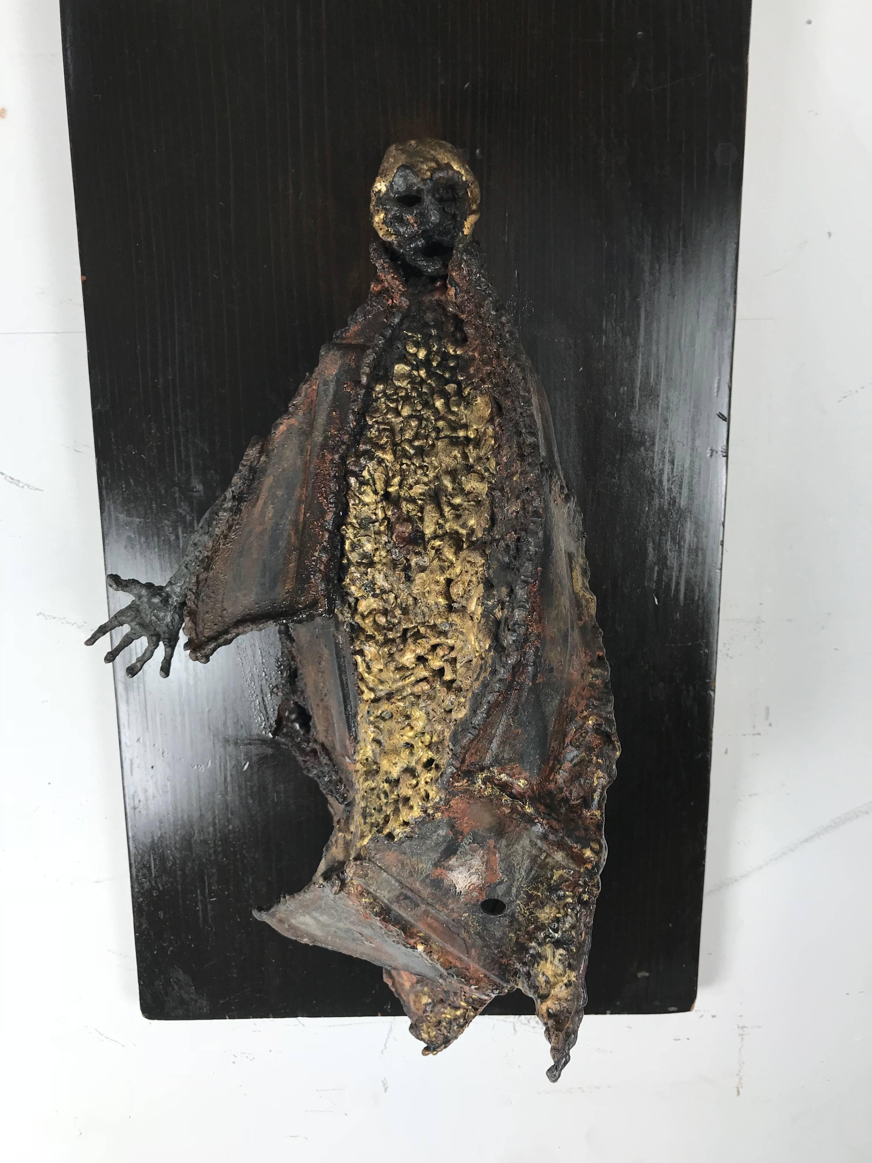 Unusual Brutalist bronze figure mounted sculpture, emotionally charged, raw imagery, beautifully hand executed, depicting cloaked person amazing texture and color, surface man measures 17 inches high x 8 inches wide x 6 inches deep.