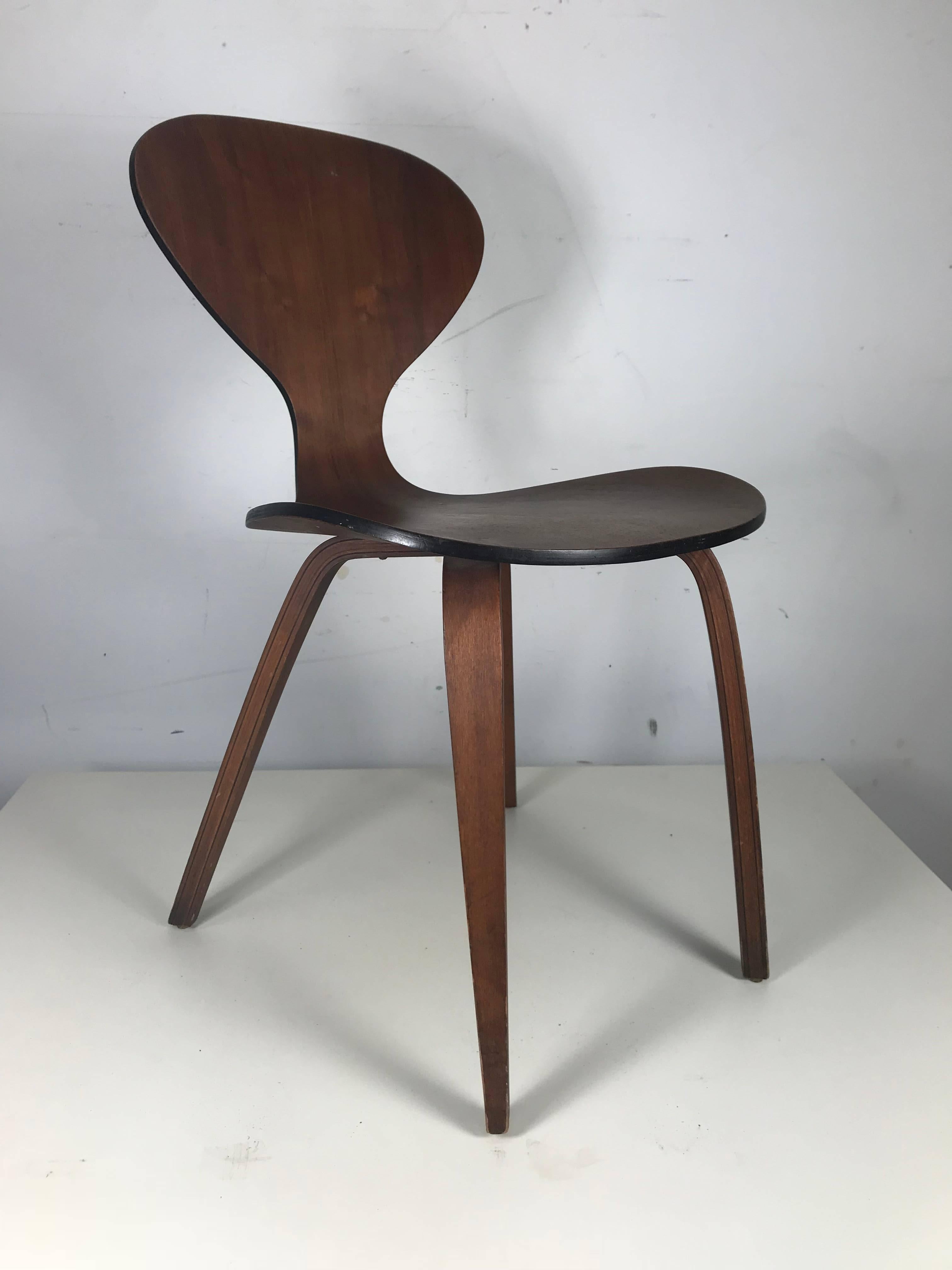 Classic Mid-Century Modern plywood chair by Norman Cherner for Plycraft. Wonderful warm walnut finish, nice original condition and patina, extremely comfortable, perfect occasional, accent or desk chair.