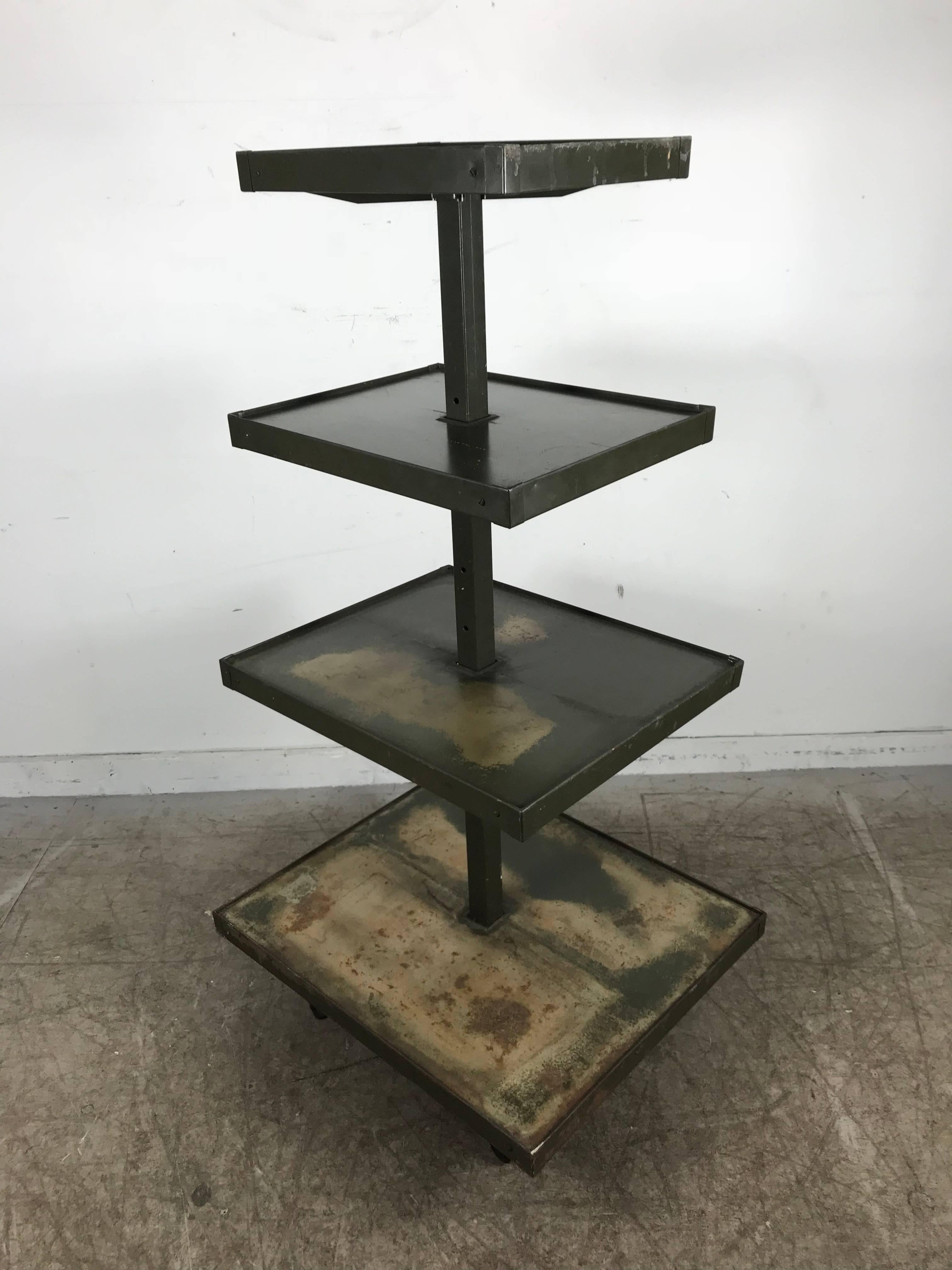 Industrial 4 tier rolling display stand,distressed finish.Dayton Display Co.Features 4 adjustable shelves measuring from bottom 26 x 22, top 12 x 16,Original surface and finish,