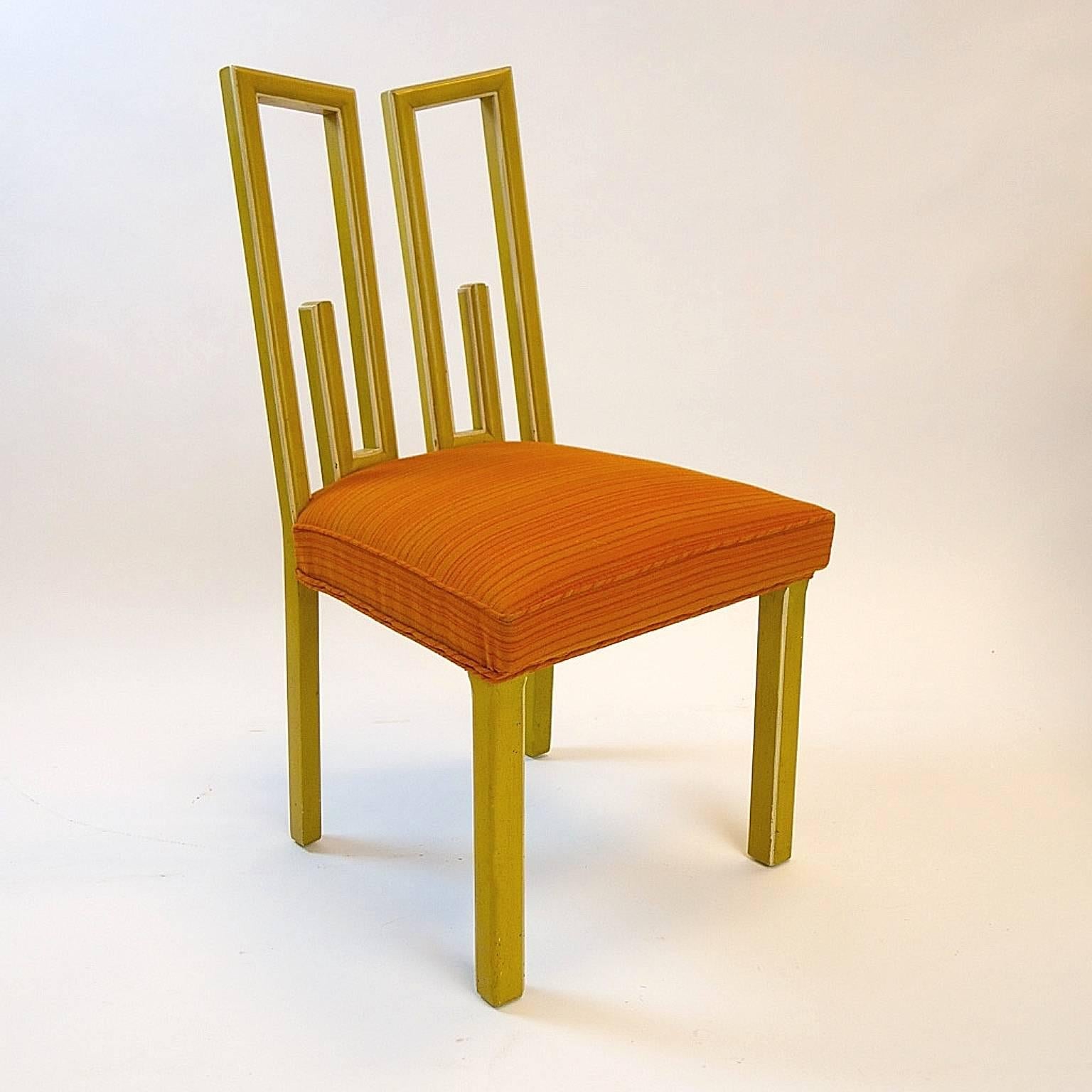 Stunning James Mont dining chairs in a vibrant and exciting color combination. Frames are finished in a gold colored speckled finish with cream colored detailing. Seat upholstery is done in a vibrant orange and in very good condition.