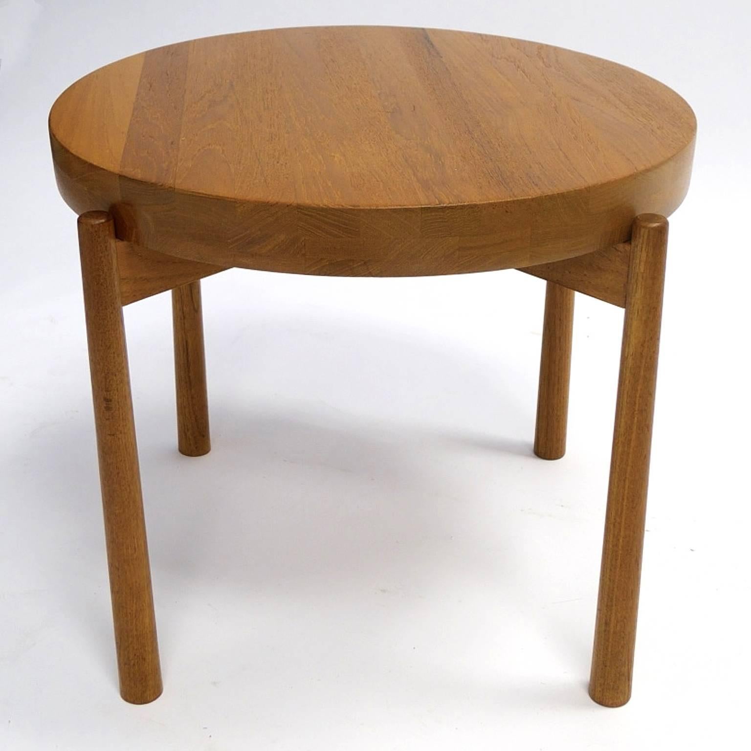 Novel pair of teak tables designed by DUX, in the manner of Jens Quistgaard. Thick solid teak tabletops. One side is concave and other side it flat. These tables are stunning and in excellent original condition.