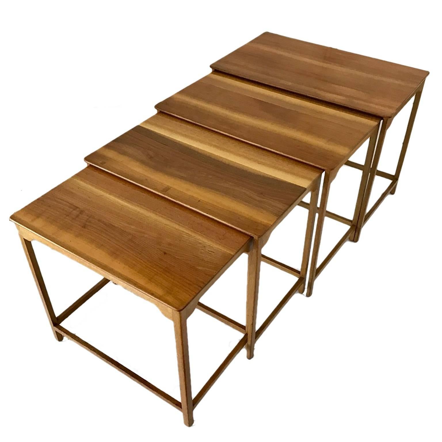 A custom ordered series of Dunbar nesting tables with mahogany bases, sap grain walnut tops. The smallest table having four stretchers and the others have three to accommodate nesting. 4790 the largest measures 26 1/4 W x 15 1/2 D x 20 1/2 H, 4789