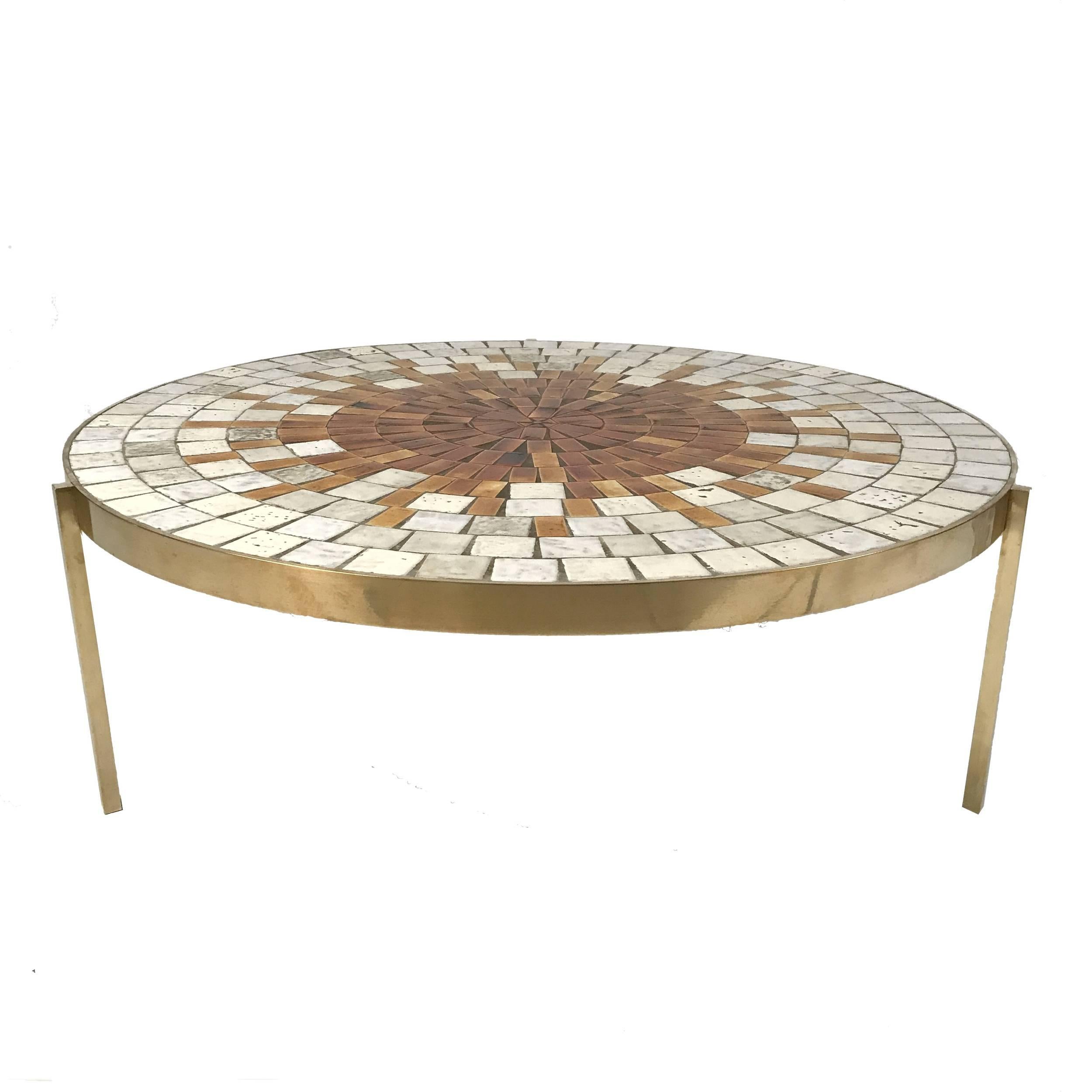 Heavy brass base with many handmade glazed ceramic tiles on top. Rare three-leg version of this table. Absolutely stunning in person.