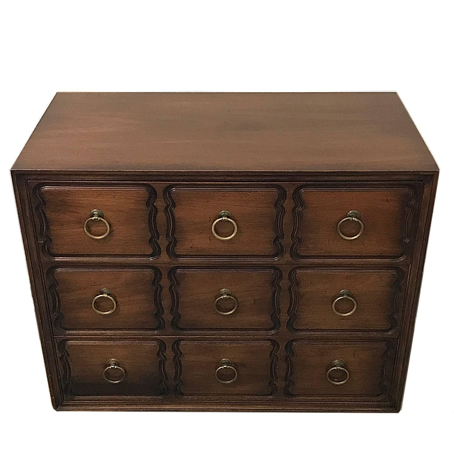 Lovely Dorothy Draper Espana style three-drawer dresser by Heritage Henredon, USA, 1950s. Burnished walnut case. Brass ring pulls. Makers mark reads: 