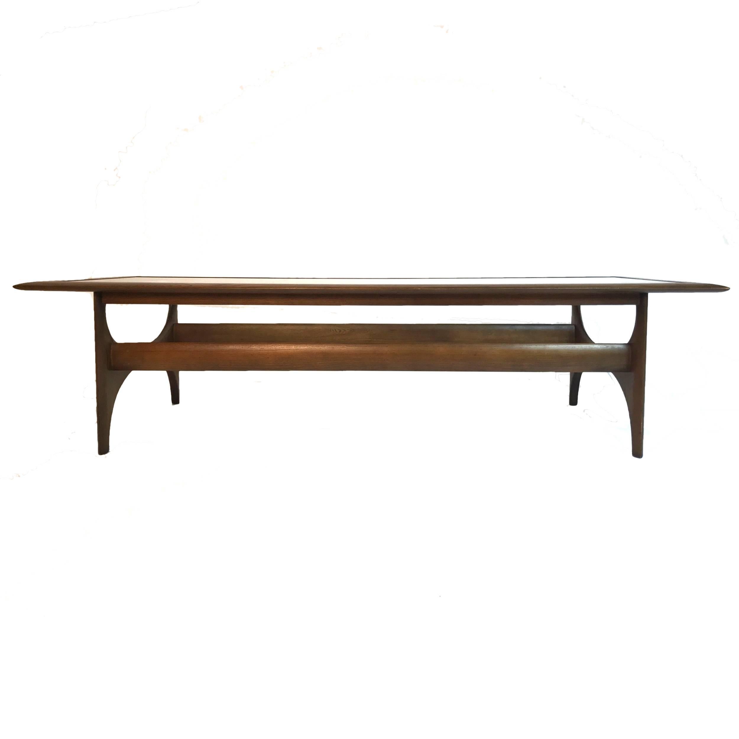 Sculptural classic midcentury design. Walnut framed table with a smoked glass insert. Beautiful piece!