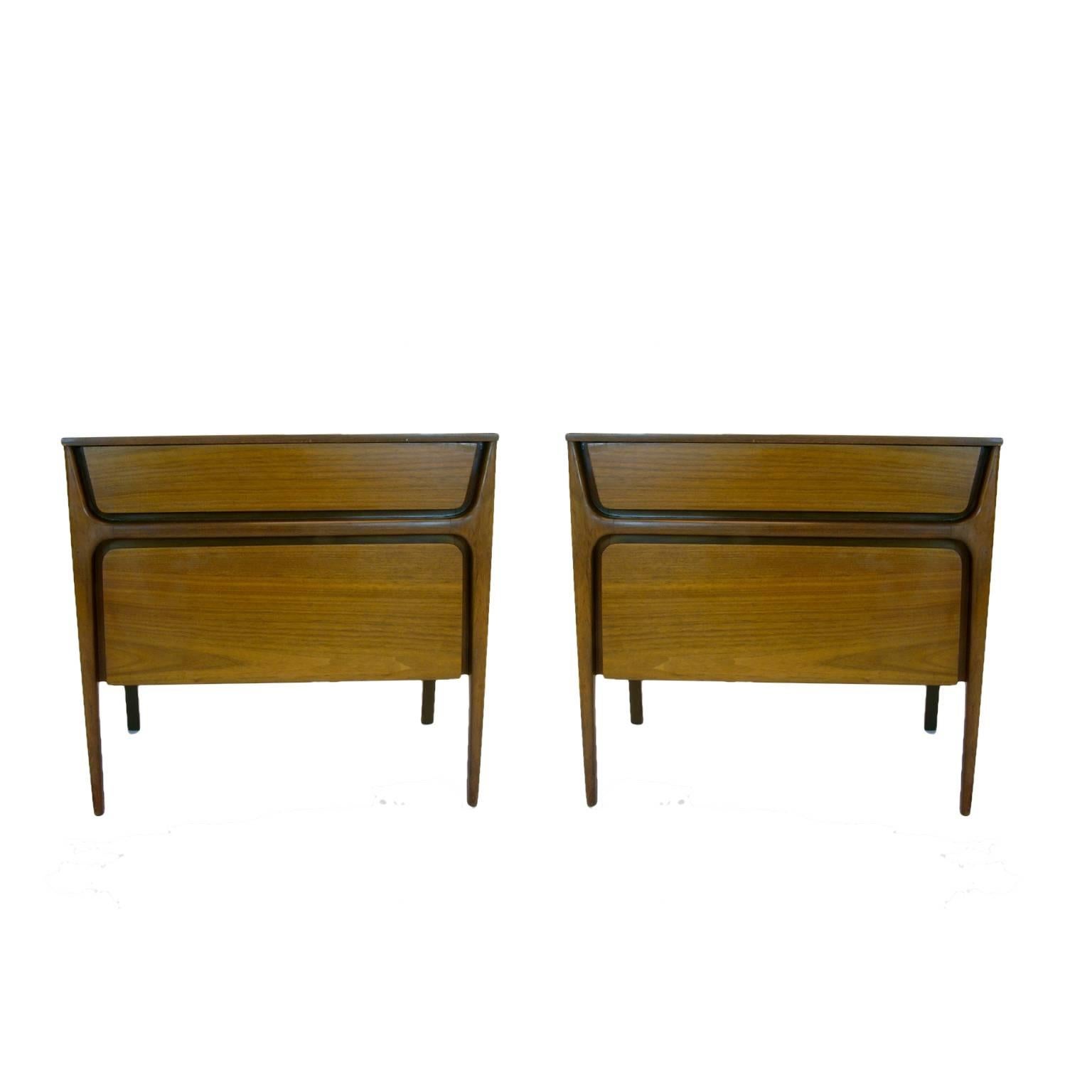 Pair of sleek 1950s sculptural nightstands with one small drawer on top and bottom portion drops down for storage. Condition is original and ok, but not perfect.
