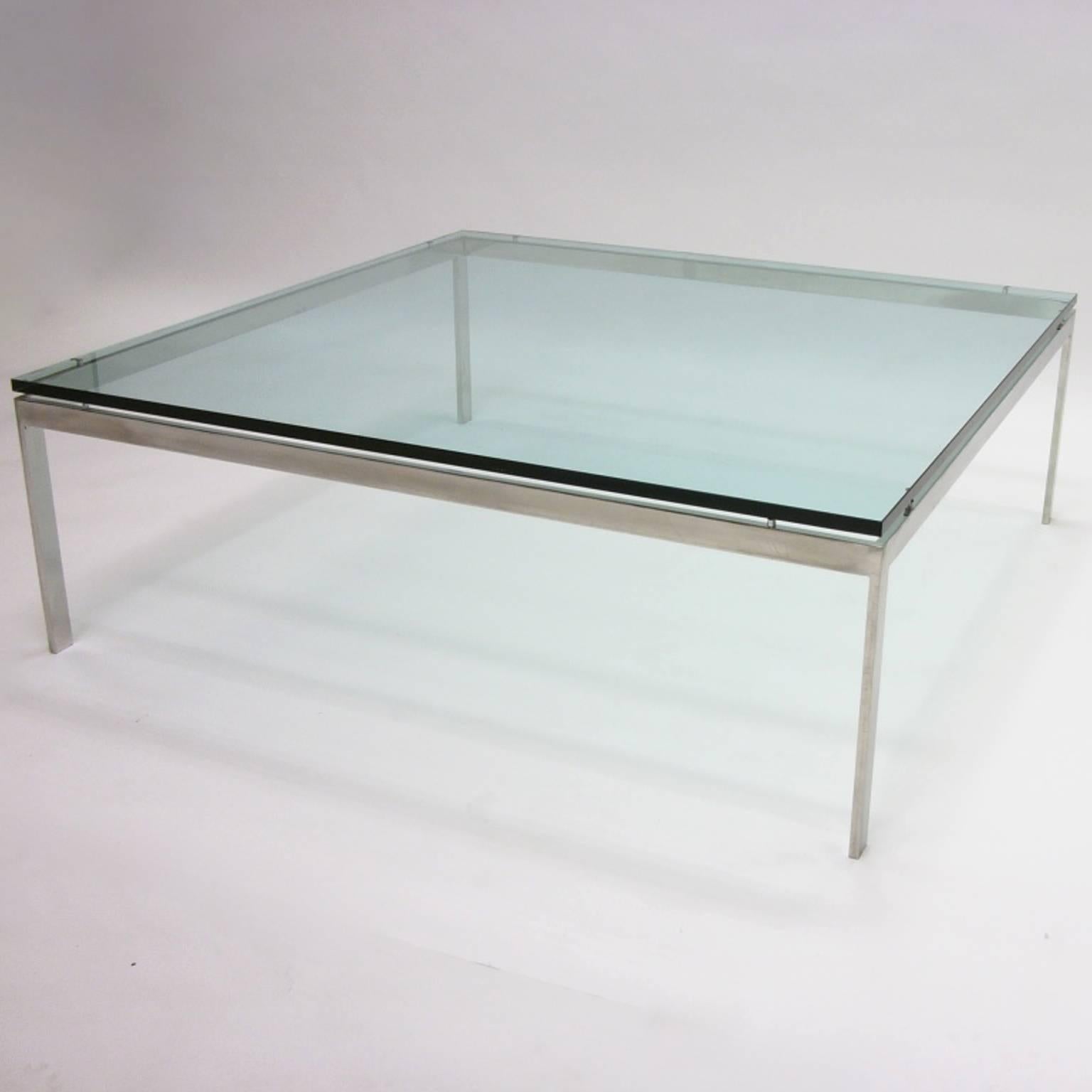 A monumental heavy stainless steel framed coffee table with floating glass top. Designed by Jacob Epstein for Cumberland Furniture.