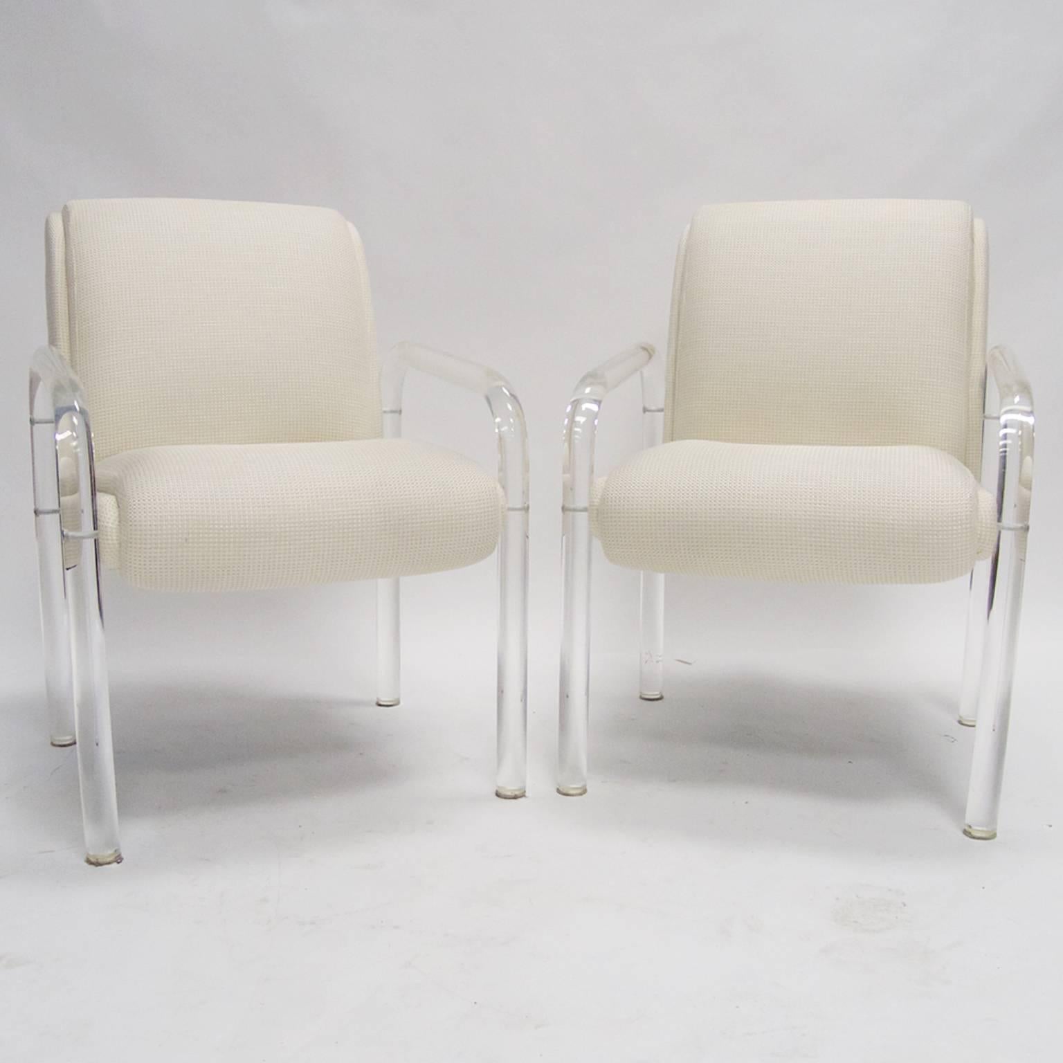 Stunning set of two curved solid Lucite armchairs designed by Leon Frost. Each chair is signed "Lion in Frost 79". The chairs are all in excellent condition with new heavy weave upholstery. Excellent condition.