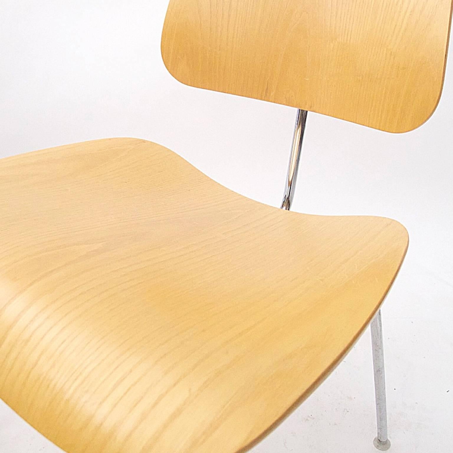 Eames DCM chairs in white ash. These superbly designed chairs have remained in production since 1949 with minor changes to the glides. All chairs are labeled and in good pre-owned condition. Some wear and surface scraping commensurate with average