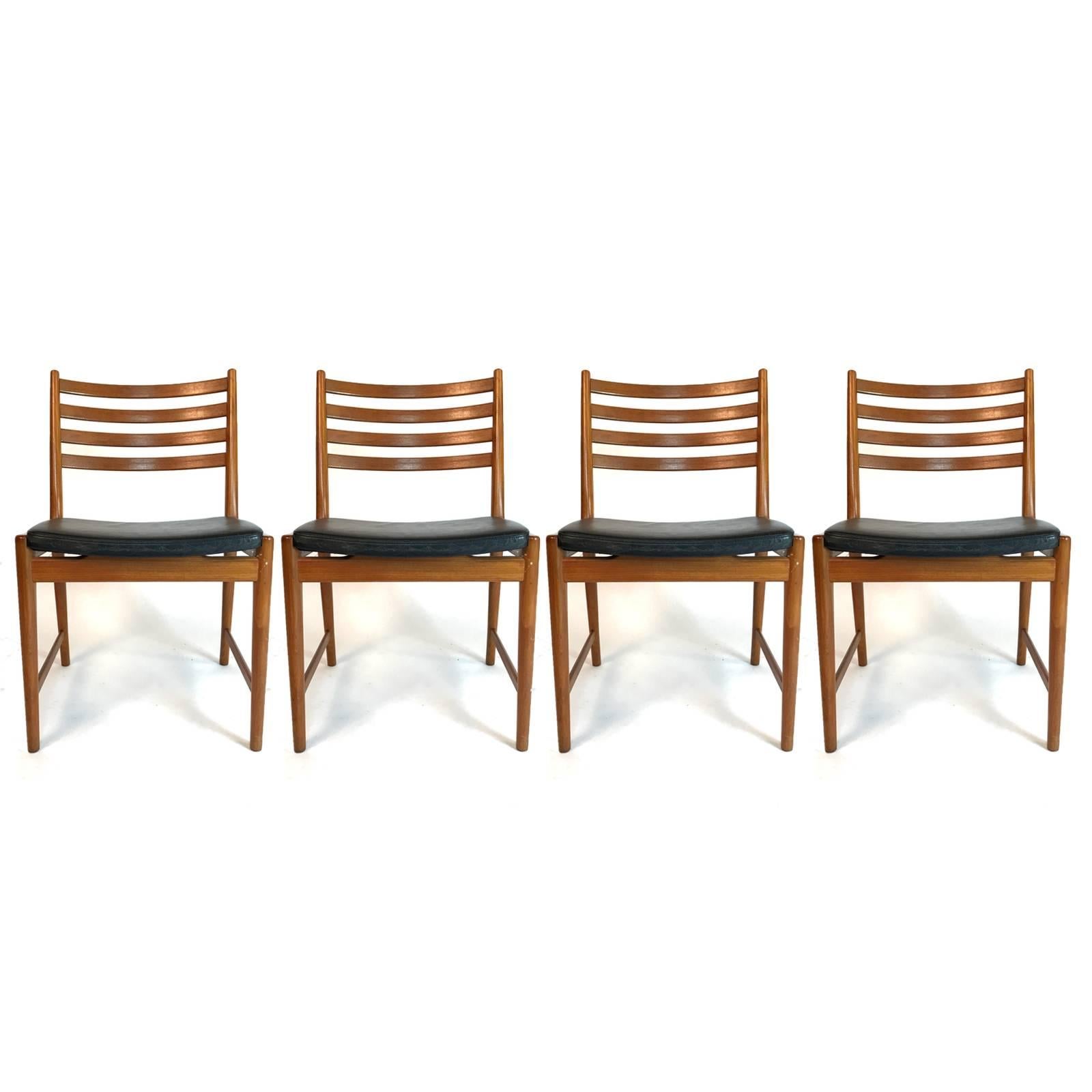 Stunning set of two armchairs and four side chairs in teak and leather by Kai Lyngfeldt Larsen. Armchairs measure: 24.25 wide x 20 deep x 31 high. Seat height 17